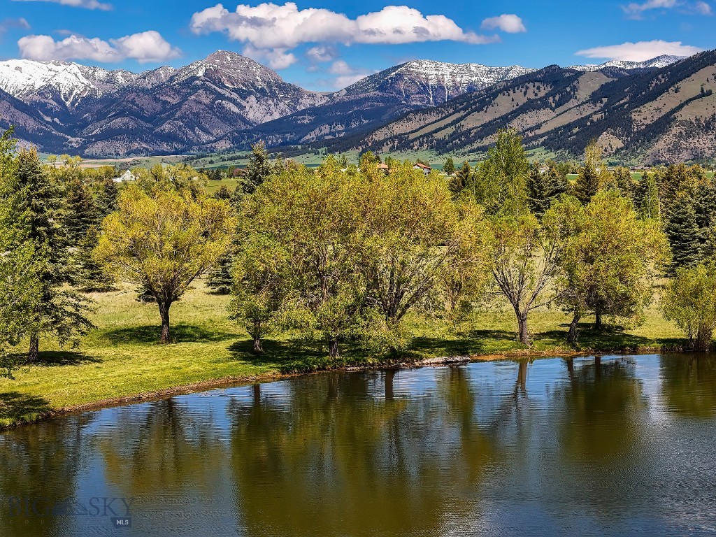 Located within the peaceful Bridger Lake Meadows subdivision, this 1.01± acre lot offers a rare opportunity to create your dream property at waters edge. Lot 5912 is located at the north end of the lake and oriented directly south capturing the full length of the lake corridor along with views of the Gallatin Range and Spanish Peaks. The Bridger Lake Meadows development showcases mature trees, lots of open space and includes private access to a 25+ acre nature park and the East Gallatin River. Perfect for those who appreciate both beauty and outdoor recreation. Ideally positioned just 5 minutes north of 19th Avenue in Bozeman, this homesite provides the perfect balance of quiet living and convenient access to city amenities. With sweeping views, access to trails and riverfront spaces, and a prime location close to Bozeman, this property represents an exceptional piece of Montana living. Lot 5912 could be combined with Lot 5902 (MLS 410935) creating over 2 acres of lake front living.