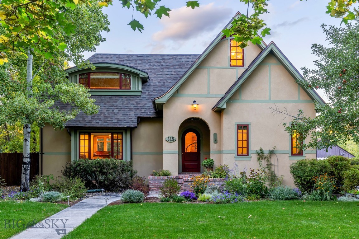 Welcome to this masterfully reimagined historic Bozeman residence blending timeless character with a high-quality renovation in the highly desirable Cooper Park area, along prestigious Cleveland Street. Originally built as a 1937 cottage, the home has undergone a meticulous, multi-year transformation that significantly increased its footprint while preserving the architectural soul that makes it so special. Original details like arched doorways, built-ins & classic millwork are seamlessly paired with expanded living spaces, modern functionality & intelligent home automation throughout. This is a fully integrated smart home — featuring Lutron light switches & motorized shades, whole-home Google Home voice command control, exterior Ring camera security, an electric vehicle charger in the garage & solar panels for exceptional utility efficiency — all working seamlessly together to make everyday living as effortless as it is refined. Inside, a formal living room opens gracefully into a charming dining area, while the expanded kitchen serves as the true heart of the home, complete with a cozy breakfast nook & a bright atmosphere that encourages everyday living & entertaining. A beautifully crafted family room addition features coffered ceilings & built-in window seating, creating a natural gathering place year-round. Upstairs, the private primary suite offers elevated ceilings, a sitting area & a dedicated office space complete with a gas stove for winter warmth & a mini-split for efficient summer cooling — ensuring comfort in every season. A custom media room with a retractable screen & built-in cabinetry adds another layer of livability, blending comfort with modern convenience. A fully equipped guest suite above the 2-car garage includes its own kitchen, living area, bedroom, laundry & private access, ideal for extended stays or visiting guests.  Set in Bozeman's highly sought-after Cooper Park neighborhood, the home offers exceptional walkability to downtown while maintaining privacy & established neighborhood charm. Lush, mature landscaping creates a private, park-like setting, with a generous backyard ideal for outdoor living & entertaining. A private hot tub invites year-round relaxation, while exterior Ring cameras provide comprehensive security & peace of mind. 515 W Cleveland Street is a thoughtfully crafted legacy property offering enduring character, modern comfort, intelligent living & a story that continues to unfold.
