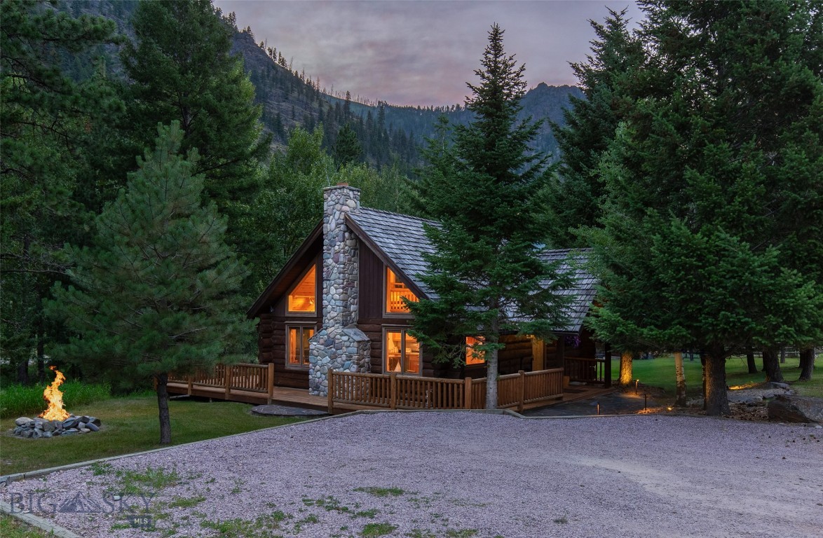 Step into the heart of the Rock Creek Valley with this custom log cabin retreat on rare deeded Blue Ribbon Rock Creek frontage, offering nearly 200 Ft of creek access. Perfectly positioned on lower Rock Creek for easy, year-round access, this property is a launchpad for outdoor adventures, world-class fly fishing, hiking, wildlife watching, and evenings by the creek side. The 1,107 Sq Ft cabin blends rugged Montana character with thoughtful craftsmanship. Exposed beams, hand-hewn logs, and a dramatic stone fireplace create a warm and inviting space, while the lofted 2 bedroom, 1 bath design creates a spacious, airy feel that’s perfect for unwinding after a day of adventure. Lovingly cared for, this property has been both a cherished family retreat and a popular, professionally managed vacation rental with strong rental history. Offered fully furnished, it’s ready for you to arrive with nothing but your gear, whether you’re seeking a turnkey investment or your own scenic river getaway.