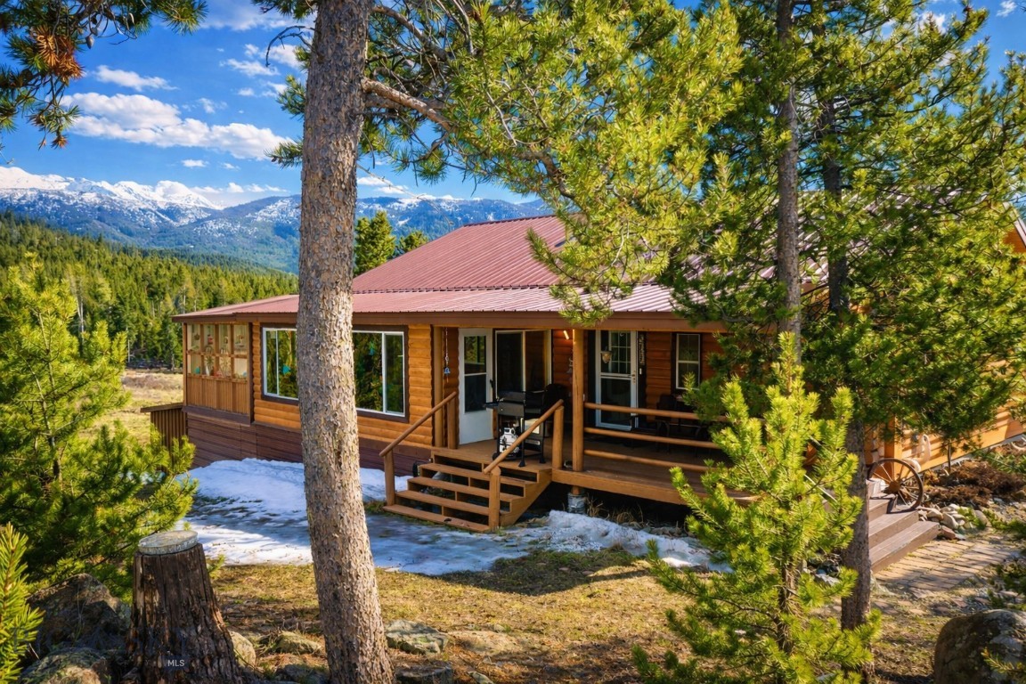 Escape to the serenity of Montana living at this stunning custom log home, perfectly positioned on over 18 pristine acres bordering expansive Forest Service land. This rare setting offers unmatched privacy, direct access to public lands, and a front-row seat to abundant elk and native wildlife.

Encompassing 2,184 square feet of thoughtfully designed living space, the home seamlessly blends rustic elegance with modern comfort. Expansive windows flood the interior with natural light while framing breathtaking, ever-changing mountain views in every direction.

Inside, warm wood tones, soaring ceilings, and fine craftsmanship create a welcoming, lodge-inspired atmosphere. Every detail reflects quality and intention, offering both comfortable daily living and an inviting space for entertaining.

The surrounding acreage is a true sanctuary—ideal for quiet reflection, outdoor recreation, or simply enjoying the sights and sounds of nature. With frequent visits from elk and other wildlife, the property delivers an authentic Montana experience that few properties can match.

Whether you’re searching for a peaceful retreat, a recreational basecamp, or a full-time residence immersed in nature, 106 Labelle Gulch Road offers a rare combination of seclusion, beauty, and accessibility—just minutes from Butte.
