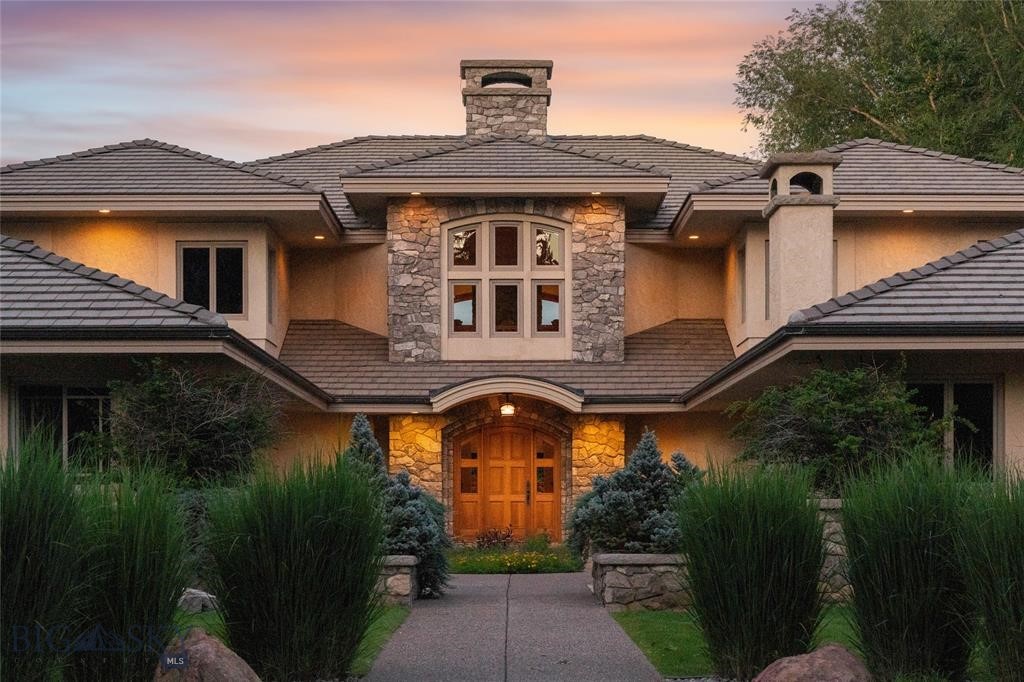 Welcome to 7,000+ sq ft of refined living on 1.8 private acres on the Missouri River — just steps from the prestigious Meadowlark Country Club. This extraordinary 5-bed, 6-bath estate blends luxury, privacy, and lifestyle. Enter through a gated drive into a serene, manicured setting where craftsmanship shines. Inside, rich custom woodwork, chef-grade Viking appliances, and a custom wine cellar set the tone for elegance. Expansive living areas, a cozy sunroom, and soaring ceilings feel both grand and inviting. At the heart of the great room, a dramatic floor-to-ceiling rock fireplace adds warmth, character and a striking focal point. Entertainment features include a sports room with full bar, plus a luxurious indoor pool and hot tub for year-round enjoyment. Outdoors, enjoy river access, a private dock, and landscaped grounds perfect for relaxing or hosting by the water. All this, in a quiet neighborhood just steps from the golf course — a private retreat designed for living well.