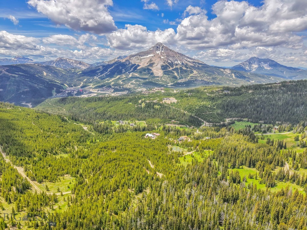 Spanning approximately 48.55± acres, this extraordinary property in the heart of Big Sky, Montana offers a rare opportunity to create a multi-generational mountain retreat or develop up to four distinct parcels—each with its own incredible building site and breathtaking views of Lone Peak, one of the most iconic backdrops in the American West.

Bordering the expansive Custer-Gallatin National Forest, which spans over 3.1 million acres of pristine wilderness, trails, and wildlife habitat, this land offers unmatched access to protected public lands, ensuring privacy, recreational access, and protected view corridors for generations to come.

The property features diverse and striking topography, including a natural spring-fed pond and year-round creek on the lower lot, creating a tranquil alpine setting rich in native flora and fauna. From every vantage point, the landscape frames panoramic vistas of Lone Mountain, high alpine ridgelines, and dramatic forested slopes.

Whether you're envisioning a family compound, a series of private luxury residences, or a singular legacy estate, this property is a canvas for world-class mountain living. Ideally located just minutes from Big Sky Resort, the Beehive Basin Trailhead, and the vibrant Town Center, you’ll enjoy unparalleled access to skiing, hiking, mountain biking, fly fishing, and all-season adventure.

This is a rare opportunity to own a significant landholding with development flexibility, natural water features, and direct forest access—all in one of the most sought-after resort destinations in the country.