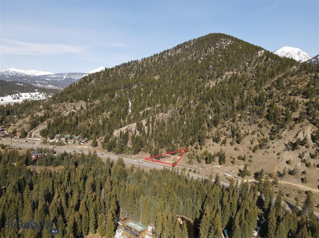 Unbeatable location, endless opportunity, extraordinary exposure and prime visibility. Less than a minute to Big Sky Conoco Travel Shoppe and the entrance to Big Sky, 5 minutes to the Town Center, 20 minutes to Big Sky Resort, 50 minutes to Yellowstone National Park’s West Entrance, Bozeman Yellowstone International Airport, and downtown Bozeman. This could be the perfect hub for your Southwest Montana adventures. No known covenants, this community commercial property provides so many unique possibilities and permitted uses – medical offices, restaurants, retail, short term rentals, special events, studios, workforce housing and so many more! Brand new septic system is installed on the property - approved for 6 bathrooms – an incredible benefit as new construction sewer and wastewater is being heavily regulated for protection of the Gallatin River.