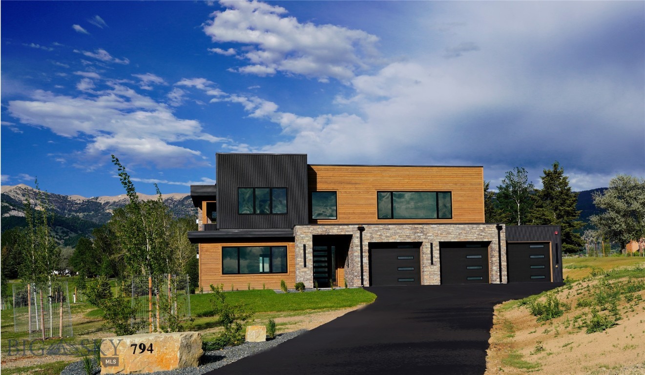 This brand-new contemporary home located in Springhill Reserve captures the essence of elevated mountain living with uninterrupted 360-degree views of the Gallatin Valley that stretches as far as the eye can see! Thoughtfully designed to blend modern architecture with the natural landscape, the home is filled with light, clean lines, and an effortless sense of openness.
Inside, every detail reflects quality and sophistication—from the beautiful high-end tile finishes in all 4.5 bathrooms to the seamless single panel wood doors that enter and exit every room. The kitchen is outfitted with premium Thermador appliances, sleek cabinetry, and refined surfaces that make it equally suited for everyday living and/or entertaining.
Expansive windows frame the surrounding mountains from every angle, creating a constant connection to the outdoors, while generous indoor and outdoor living spaces invite you to relax, gather, and take in the views year-round.  A large covered upper deck invites you to gather anytime with a gas fireplace, entertainment hook-ups, and is wired for electrical outdoor heat lamp. This exceptional property is waiting for you to call it HOME!