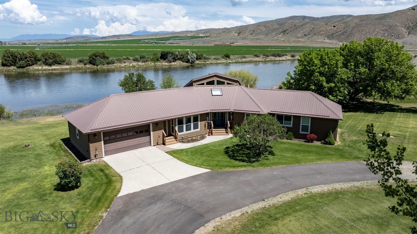 MOTIVATED SELLERS!!

Where Every Day Feels Like a Montana Getaway
Imagine ending each day with a soak in the hot tub overlooking the Missouri River, watching the sun set behind the mountains while eagles soar overhead. This exceptional riverfront property offers a rare opportunity to enjoy the best of Montana living every day—combining natural beauty, privacy, recreation, and comfort in one remarkable setting.

With 258 feet of Missouri River frontage, fishing, kayaking, canoeing, and wildlife watching begin right outside your door. The expansive deck provides a front-row seat to Montana's changing seasons, panoramic mountain views, and the peaceful rhythm of life along the river.
Designed to capture the surrounding landscape, the custom home features oversized windows that fill the open-concept living spaces with natural light and breathtaking views in every season. Whether enjoying a quiet morning coffee, entertaining friends, or hosting visiting family, the home offers a warm and inviting setting for making lasting memories.

Outside, beautifully landscaped grounds include more than 50 trees, a fenced garden with raised beds, underground sprinklers, and ample space to relax and unwind. Additional garage and shop space provide room for vehicles, boats, recreational equipment, hobbies, and projects.
Located within the Missouri River Rendezvous community, residents enjoy access to a golf course, park, and boat launch, while nearby public lands offer even more opportunities to explore. Conveniently situated between Three Forks and Townsend, with Bozeman and Helena within easy reach, the property combines the serenity of a private retreat with the convenience of nearby amenities.
Whether you're seeking a year-round residence or a place to enjoy the next chapter surrounded by Montana's natural beauty, this is more than a home—it's a lifestyle. Here, vacation isn't something you plan. It's how you live. 

Call to schedule your showing today!
