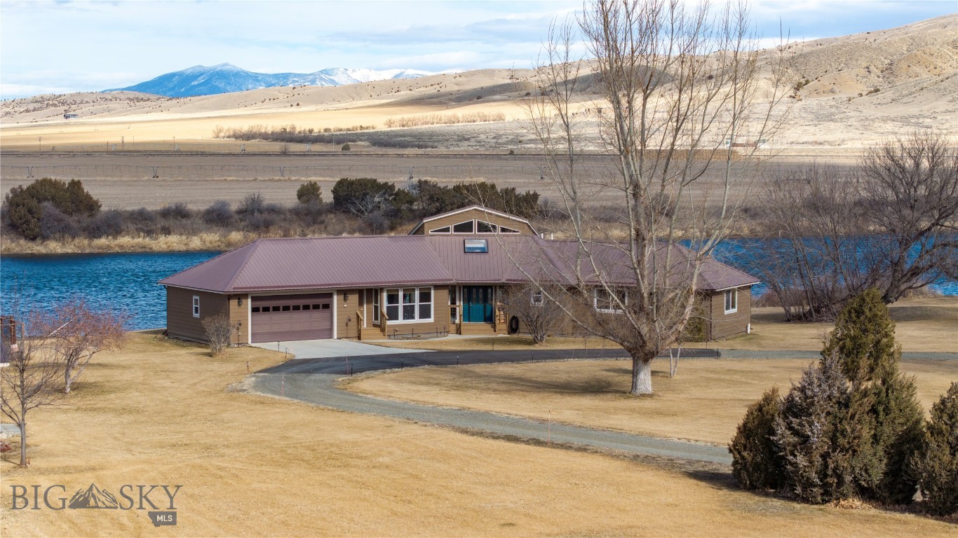 MOTIVATED SELLERS!!

Where Every Day Feels Like a Montana Getaway
Imagine ending each day with a soak in the hot tub overlooking the Missouri River, watching the sun set behind the mountains while eagles soar overhead. This exceptional riverfront property offers a rare opportunity to enjoy the best of Montana living every day—combining natural beauty, privacy, recreation, and comfort in one remarkable setting.

With 258 feet of Missouri River frontage, fishing, kayaking, canoeing, and wildlife watching begin right outside your door. The expansive deck provides a front-row seat to Montana's changing seasons, panoramic mountain views, and the peaceful rhythm of life along the river.
Designed to capture the surrounding landscape, the custom home features oversized windows that fill the open-concept living spaces with natural light and breathtaking views in every season. Whether enjoying a quiet morning coffee, entertaining friends, or hosting visiting family, the home offers a warm and inviting setting for making lasting memories.

Outside, beautifully landscaped grounds include more than 50 trees, a fenced garden with raised beds, underground sprinklers, and ample space to relax and unwind. Additional garage and shop space provide room for vehicles, boats, recreational equipment, hobbies, and projects.
Located within the Missouri River Rendezvous community, residents enjoy access to a golf course, park, and boat launch, while nearby public lands offer even more opportunities to explore. Conveniently situated between Three Forks and Townsend, with Bozeman and Helena within easy reach, the property combines the serenity of a private retreat with the convenience of nearby amenities.
Whether you're seeking a year-round residence or a place to enjoy the next chapter surrounded by Montana's natural beauty, this is more than a home—it's a lifestyle. Here, vacation isn't something you plan. It's how you live. 

Call to schedule your showing today!