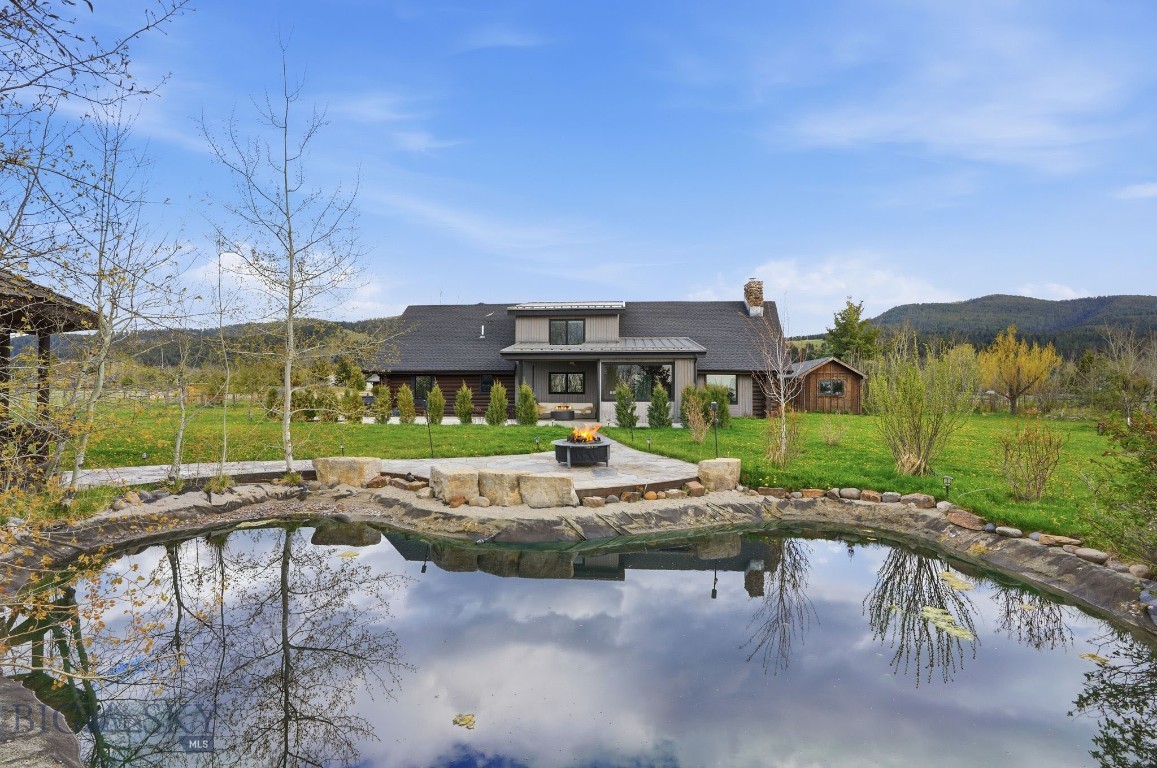 Set quietly on 3.27 acres in the Hyalite Foothills of Bozeman, this property offers a rare combination of privacy, usable land, and unobstructed mountain views, just minutes from town. Opportunities like this are increasingly limited and difficult to replicate at any level.

Originally built in 1978, the home has undergone a complete, seven-figure transformation. This is not a cosmetic update, but a full structural and spatial reconfiguration designed for modern living, natural light, and long-term functionality.

Inside, expanded sightlines and large sliding doors bring the surrounding landscape into the home, creating a seamless indoor-outdoor connection throughout the seasons. The main living area is anchored by a black limestone wood fireplace beneath vaulted ceilings, balancing scale with warmth.

The kitchen is built to perform, featuring Wolf, Viking, and Cove appliances, dual Galley workstations, a walk-in pantry, and custom cabinetry designed for both efficiency and clean design.

The main level includes two dedicated offices, supporting a true work-from-home lifestyle. A third primary bedroom, currently used as a gym, features large sliding doors and functions easily as a main-level suite.

Upstairs, the owner’s suite is positioned for privacy, alongside a junior suite and an additional living area with a built-in kitchenette, ideal for guests, extended family, or flexible use. Bathrooms are finished in marble with Restoration Hardware vanities, reinforcing the level of quality throughout.

Beyond the home, the property expands into a fully functional compound. A newly constructed oversized four-car garage is complemented by a multizone workshop, greenhouse, sauna, gazebo, and additional utility structures—offering space for projects, storage, or future adaptation.

Outdoor living is integrated, not added on. A glass-framed, four-season extension with ceiling-mounted heaters creates a year-round gathering space. A sauna, hot tub, and pond introduce moments of privacy and restoration across the landscape, while mature plantings provide natural screening without compromising openness.

Every major system, structure, and finish has already been addressed, eliminating the time, cost, and uncertainty most buyers face when improving rural properties.

Recreating this property today, with land, construction, and improvements, would require significantly more capital, extended timelines, and complex coordination.