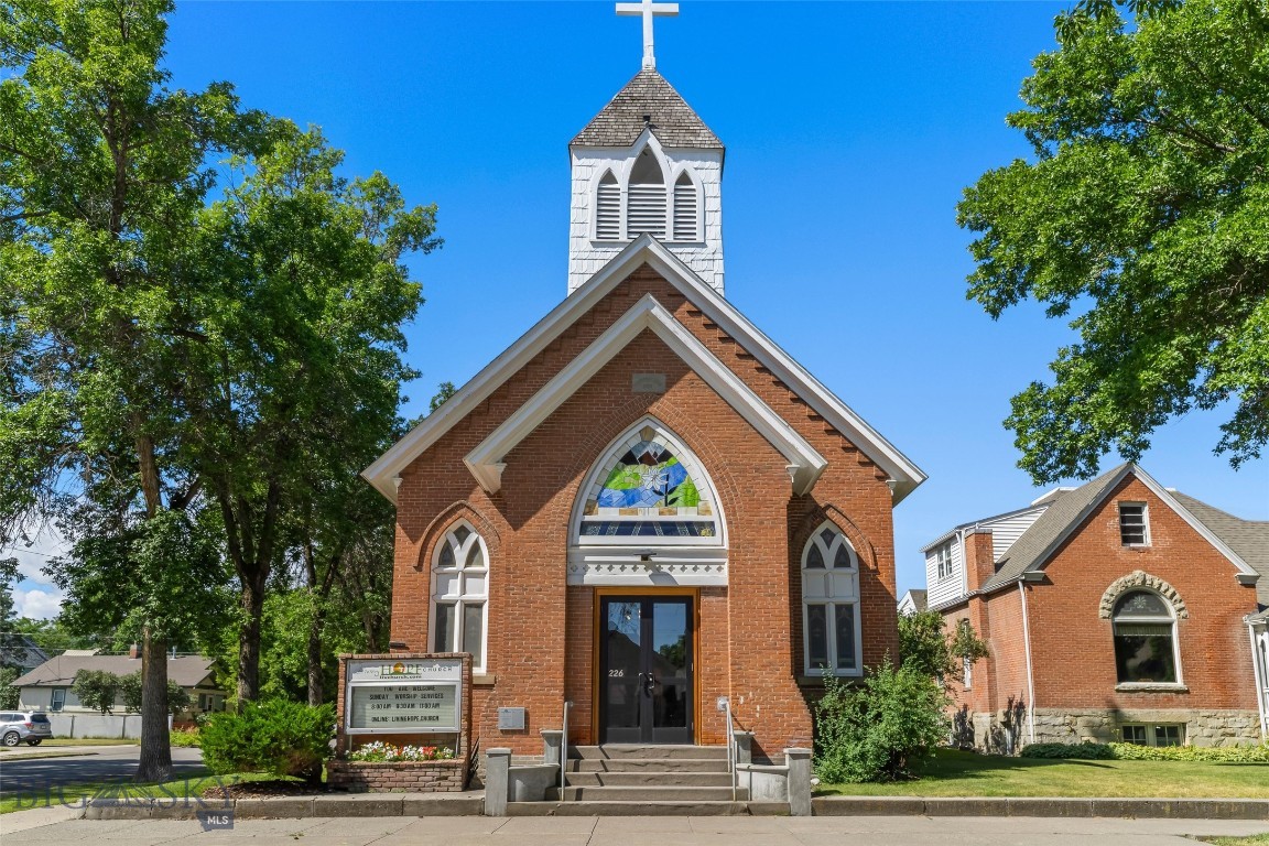 Few opportunities arise to own a truly historic treasure in downtown Livingston, MT. Listed on the National Register Of Historic Places, this landmark began its story in the late 1800's, originally built as the Saint Mary's Catholic Church. Today, its distinctive brick facade, vibrant stained glass windows, and iconic bell tower preserve exceptional character and charm. This unique property includes both the original church building and parsonage, situated on 5 lots, offering expansive space and incredible potential for a variety of uses. Property highlights include: historic architecture with irreplaceable details throughout; dramatic open spaces beneath soaring ceilings; picture rails for period-appropriate art display; historic doorknobs and hinges that add authentic charm; ornate light fixtures reflecting the property's history; and a classic horse hair plaster light fixture, a mark of true vintage craftsmanship. Most recently serving as the Living Hope Church, this property has been a place of community, memories, and events since 1964 when the congregation was first founded. Zoned R2 medium density residential, it is perfect for residential or adaptive reuse (buyer to verify zoning compliance with city officials). Prime downtown location near shops, dining, and amenities. Don't miss this rare chance to claim a piece of Livingston past and shape its next chapter. Also see MLS#404613 & #404618
