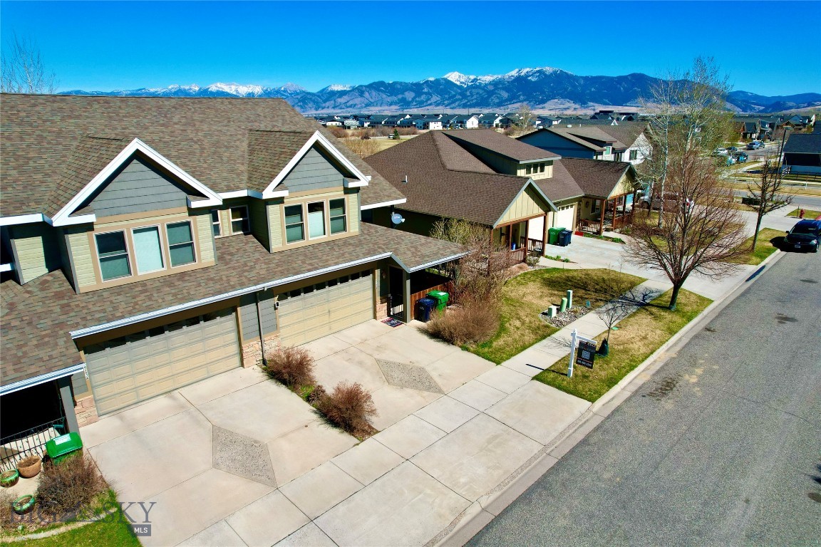 This wonderful two story, 4-bedroom, 3-bathroom, renovated condominium with high end craftsmanship unlike anything else on the market! A beautiful and oh so functional layout makes living, working and playing here easy. Enjoy quality craftsmanship in freshly refinished oak hardwood floors, tiled bathrooms, entry foyers and laundry room.  This home is outlined in solid wood trim throughout, spacious / vaulted ceilings, and ample natural light provided by large windows and patio glass doors. A new roof was installed in 2019, new AC in 2021, new furnace in 2025. Other amenities include stainless steel appliances, granite countertops, a two car attached garage, and a lovely covered private front patio for morning coffee and back patio for grilling. This home provides a perfect space for entertaining with friends and family, inside and out. It is wired with fiber high speed internet and as well as broadband.  The family room is complimented by a beautiful gas fireplace, creating an inviting and cozy atmosphere.  There are walk-in closets and jacuzzi tub in primary bedroom. There is a lovely and spacious back yard to play catch with the kids, or enjoy views of the Bridger Mountains. Walking distance to Gallatin High School, Meadowlark Elementary, and several parks, numerous trails, and ponds. The home is centrally located and close proximity to shopping, restaurants, and all types of recreation.  It is minutes from fly fishing on the Gallatin River, and also easy access to the airport, Big Sky and Bridger Bowl ski hills. Seller is offering an interest rate buy-down to all potential buyers. Contact me today with questions or to schedule a showing.