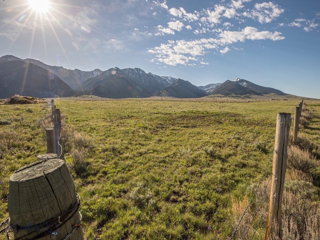 Located just 3.4 miles south of the storied Madison River and the Raynold's Pass fishing access, with no covenants or zoning, this 80 acres is a blank slate for your dreams! Fabulous trout fishing on the Madison River and multiple nearby lakes, including Cliff and Wade Lakes, Hebgen Lake, Quake Lake, Henry's Lake and Yellowstone Lake make this an angler's haven.  The huge local elk population, along with deer and big horn sheep also makes this a terrific hunter's basecamp. This property boasts panoramic views of show-capped mountain ranges and the expansive sky that make Montana famous. 

Views to the west are protected by conservation easement on the Three Dollar Ranch. Another large nearby ranch is also in conservation easement, which will greatly restrict sprawl and enhance wildlife migration in the area.

This unique property enjoys approximately 1,350 feet of frontage along MT HWY 87 and year-round access via the already installed and MDOT approved entrance.

Just 45 miles to Ennis and 27 miles to the West entrance of Yellowstone National Park. The airport in West Yellowstone is only 28 miles away for non-winter commercial flights and the Ennis/Big Sky Airport is 40 miles away for private aviation. More flights year-round are available in Bozeman, which is 98 miles away.