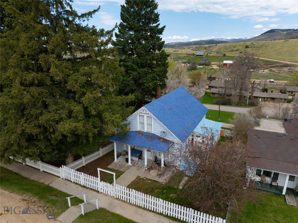 Charming Historic Home in the Heart of Virginia City
209 E Idaho Street, Virginia City, Montana
Step back in time with this unique and spacious home in the heart of historic Virginia City. Originally built in 1904 and thoughtfully updated in 1975, this multi-level family home is full of character, versatility, and potential. Set behind a charming white picket fence with a fenced yard, the property boasts breathtaking mountain views and sits just steps from the vibrant center of town.
The main floor welcomes you with an oversized living and family room featuring high ceilings, vintage molding, and turn-of-the-century charm. Two generously sized bedrooms are located on this level—one with its own side entrance, making it ideal as a guest room, office, or private suite. A full tile bathroom serves the main level, while the kitchen and adjoining dining area offer a warm, family-style space to gather. Just off the kitchen is a large den/sunroom, perfect for a hobby studio, workout space, or creative retreat. A second sunporch—also functioning as the laundry room—extends off the main living space and offers additional light and flexibility.
Upstairs, you'll find a massive, non-conforming master bedroom with enormous closets, attic storage, and stunning views of the surrounding mountains and town. A half bath with shower and an additional bedroom or office space complete this level, making it ideal for a private owner’s retreat, rental suite, or home office setup.
The basement is accessible through the kitchen or via the alley and former garage entry. It features retro finishes including vintage paneling, shag carpeting, and a built-in bar area, along with a covered porch room perfect for a home gym or storage. All utilities are housed here, and the home is heated by both heating oil (main and upper levels) and a wood stove located in the enclosed garage-turned-workshop, which also supplements heating throughout the house.
Each floor can be closed off with doors, creating the opportunity for multi-unit living, rental potential, or flexible private use. This home is being sold as is and is ideal for those seeking a primary residence, investment property, or vacation rental in one of Montana’s most historically rich and scenic towns.
Don’t miss your chance to own a piece of Virginia City’s past—with the space and character to shape its future.