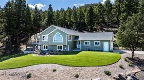 Welcome to 16 Evergreen in Clancy, a meticulously maintained 4-bedroom, 3-bathroom Montana home set on 5+ acres with natural rock outcroppings, mature landscaping, and beautiful views of the Sleeping Giant. If you’ve been looking for a property that feels tucked into the woods while still being about 15 minutes from town and the airport, this one offers that rare balance of privacy, convenience, and true Montana character. Inside, warm hardwood floors and an inviting open-concept kitchen and dining area create a comfortable flow for everyday living and entertaining. The main living spaces extend onto a spacious deck, perfect for hosting, enjoying quiet mornings, or winding down after a long day. The bedrooms are generously sized with ample closet space, and the primary suite offers a relaxing retreat with a spa-like bathroom, including a Bluetooth-enabled shower that remembers your preferred settings. Outside, the setting is peaceful and memorable. A waterfall feature tucked among the trees creates a romantic place to unwind in the evenings, with the soft sound of water, star-filled skies, and room to simply enjoy the quiet. The attached garage is oversized with great storage and workspace, and the detached 2-car garage offers even more flexibility for a shop, extra storage, tools, toys, or outdoor gear. Wildlife is part of the everyday experience here, with deer, elk, and wild turkeys frequently moving through the property. Owners have even harvested game from their back door. Located in Hunting District 380 with BLM land close by, this property offers easy access to the outdoor lifestyle Montana is known for. Move-in ready, beautifully cared for, and surrounded by a tranquil mountain setting, 16 Evergreen is a special opportunity to enjoy space, views, wildlife, and the comfort of home all in one.