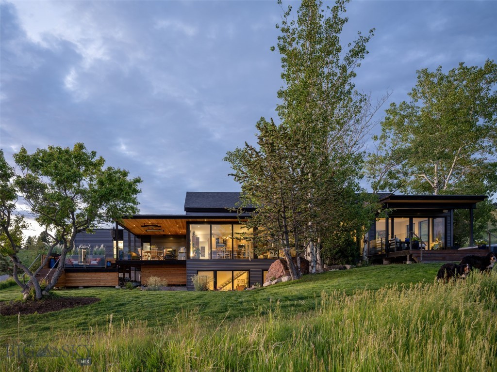 Perched atop one of Bozeman's most coveted hilltop settings, this extensively renovated contemporary residence captures some of the most breathtaking and unobstructed views in the Gallatin Valley. Situated on nearly 1.4 acres in sought-after Grandview Heights, the property lives far larger thanks to neighboring 20- and 40-acre parcels that preserve an extraordinary sense of space, privacy, and openness rarely found so close to town.

A dramatic wall of windows frames panoramic views stretching across the valley floor to multiple mountain ranges beyond, creating a daily backdrop of unforgettable sunrises, sunsets, and abundant wildlife. Deer, elk, moose, Bear, fox, coyotes, and countless birds are frequent visitors, offering a front-row seat to Montana's natural beauty from the comfort of home.

Nearly every surface of the home has been thoughtfully reimagined over the past four years with luxury finishes, contemporary design, and exceptional attention to detail. The open-concept floor plan is equally suited for everyday living and entertaining, featuring a stunning chef's kitchen, coffee bar, dedicated wine room, and multiple gathering spaces designed to embrace the surrounding views.

Outdoor living is equally impressive, with multiple decks and patios, a hot tub, beautifully executed low-maintenance landscaping, and endless opportunities to enjoy the peaceful setting. The newly updated exterior showcases striking cedar and aluminum siding, while the oversized three-car garage includes a substantial shop area ideal for hobbies, storage, or projects.

Homes in Grandview Heights rarely come to market. Located just north of Bozeman city limits, this property offers convenient access to downtown Bozeman, Bridger Creek Golf Course, Crosscut Mountain Sports Center, Snowfill Recreation Area, and the future Bike Park, while maintaining the privacy and serenity of a true Montana retreat.

World-class views. Complete renovation. An irreplaceable setting. This is Bozeman at its finest.