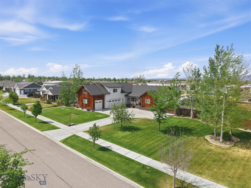 OPEN HOUSE THIS SUNDAY MAY 3rd. 1-3pm.  PLEASE STOP BY AND VISIT US! Are you dreaming of more space, more freedom? Elevate your lifestyle to new heights in this stunning Montana sanctuary, where your sprawling 2951sf space meets unparalleled luxury. Set on an expansive half-acre lot, this home is a masterpiece of design, perfectly catering to your active spirit with room for every toy—including a deep three-car garage, new shed, and full 5th-wheel camper hookups.
Step inside and feel the rush of soaring vaulted ceilings accented with wood timbers, anchored by a show-stopping real stone fireplace that radiates warmth and sophistication. This 4-bedroom, 4-bathroom trophy home is outfitted to the nines with high-end finishes that redefine "farmhouse chic." The kitchen is a chef’s dream, featuring rustic brick walls, majestic timbers, double ovens, cooktop, huge island with prep sink, and 4 pantry's with a walk-in pantry equipped with a beverage cooler, butcher block countertops, designer lighting, ample storage and extra refrigeration for effortless entertaining. Your guest will never want to leave the luxury of the upstairs guest suite complete with family room, work out space, bedroom, full bathroom and coffee station.
Whether you’re a baker harvesting fresh fruit from your private apple and cherry trees or a hobbyist organized in the custom-built work station, this home empowers your passions. After a day of mountain adventures, retreat to the luxurious Primary Suite for a spa-level experience in the glass-enclosed tiled and stone shower, stunning dual vanity and soaking tub, or sink into your Hot Springs hot tub under the Big Sky. From morning coffee on the covered deck to twilight stories around the professionally built fire pit, every inch of this property is designed for those who live life out loud. Enjoy the subdivision park space with pond and walking trails for you and your furry friends. House is also equipped with a water softener, AC, and a security system. Your extraordinary Montana life starts here. Call and make your appt today!