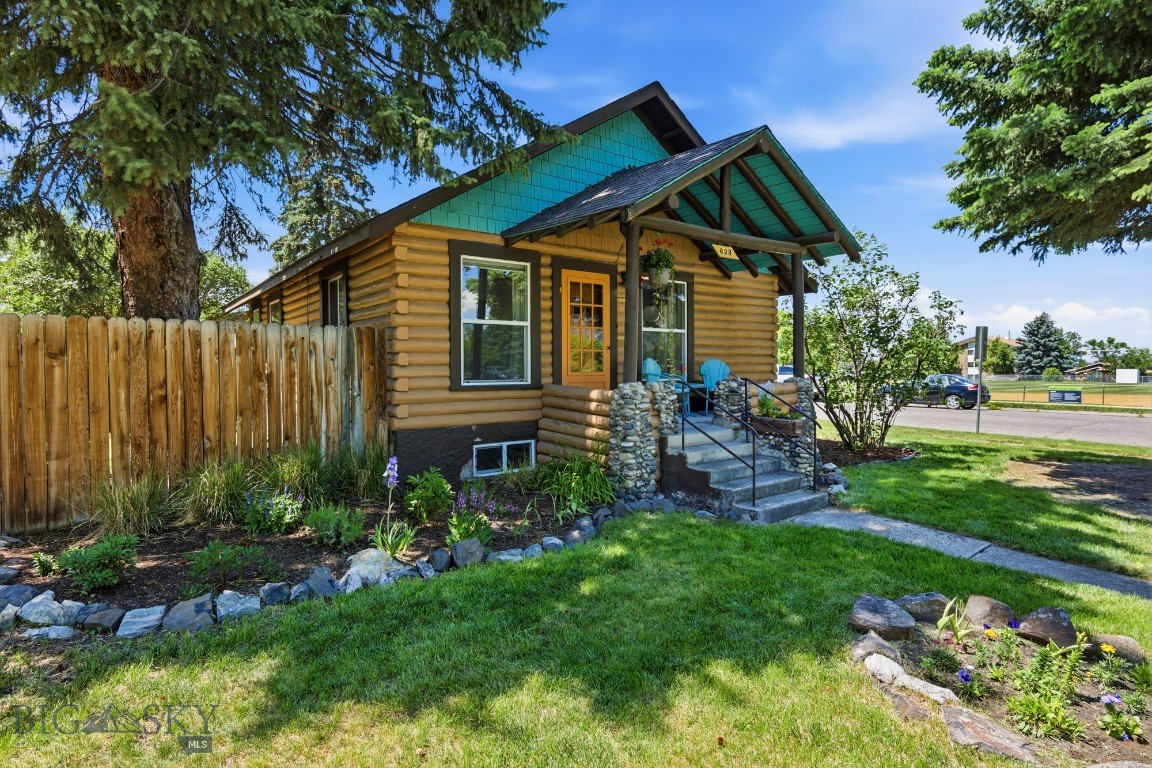 Cool, collected, and undeniably Bozeman, this vintage 1942 log home embodies the character and authenticity that have made the Northeast Neighborhood one of the city's most coveted addresses. Occupying a prized end-of-block location directly across from Centennial Park, the property enjoys unobstructed views of the majestic Bridger Mountains—a setting that feels increasingly rare this close to Downtown Bozeman.  Authentic charm in  one of the city's most vibrant and walkable lifestyles, this thoughtfully maintained residence offers character, comfort, and opportunity on an alley-loaded 6,850± square foot lot. Whether enjoying morning coffee with the mountains as your backdrop, an evening stroll through the neighborhood, or a quick bike ride to your favorite downtown coffee shop, brewery, or restaurant, this location captures the essence of Bozeman living.  Rich with vintage appeal and timeless character, the 1,416± square foot home spans two levels and features three bedrooms and one full bath. The original log exterior is complemented by a finished sheetrock interior, creating a warm and inviting environment that blends rustic authenticity with everyday functionality. A covered breezeway connects the home to the detached two-car garage, including one extra-tall bay ideal for larger vehicles, outdoor gear, or workshop space. Recent improvements and thoughtful maintenance contribute to a property that feels comfortable, cared for, and ready for its next chapter.  Outside, the fully fenced backyard and side yard provide ample room for gardening, entertaining, or simply enjoying Montana's long summer evenings with both your two-legged and four-legged companions.  Just minutes from Downtown Bozeman, NE Neighborhood and the Cannery District's restaurants, galleries, boutiques, trails, and cultural amenities, this is a rare opportunity to own a piece of Old Bozeman in a neighborhood where vintage homes, mature trees, park frontage, and mountain views continue to define one of the city's most desirable settings. Comfortable and full of character, this home offers a lifestyle every bit as appealing as the property itself.