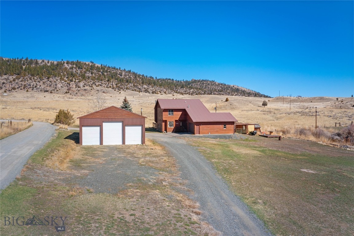 Welcome to this inviting 3-bedroom, 2-bath home set amidst breathtaking mountain views and abundant Montana wildlife. Deer, elk, and even moose are frequent visitors, creating a true nature-lover’s retreat. Rader Creek meanders through the northeast corner of the property.
The home features a functional and comfortable layout, with one bedroom and full bath on the main floor, and two additional bedrooms upstairs, including the primary bedroom. Enjoy the added luxury of an in-home sauna—perfect for relaxing after a day outdoors.
The former garage has been thoughtfully converted into an expansive entertainment space, complete with a live-edge wood bar top and a pool table, making it ideal for hosting gatherings.
Step outside to the back patio, which overlooks open pasture with views stretching to the foothills of the Highland Mountain Range—an ideal backdrop for quiet mornings or evening sunsets.
The property also includes an approximately 32' x 48' insulated shop equipped with 220-volt power and three garage doors (two approximately 8'10" x 9'10" and one approximately 9'10" x 12'), providing ample space for equipment, hobbies, or storage. The shop is already set up for a wood burning stove, including the installed stove pipe. 
Conveniently located less than 4 miles from Deer Lodge National Forest via Hwy 2, this property offers easy access to outdoor recreation while maintaining privacy and scenic beauty. The town of Whitehall is approximately 10 miles away and Butte is approximately 22 miles away.
This is Montana living at its finest—where comfort, functionality, and the great outdoors come together.