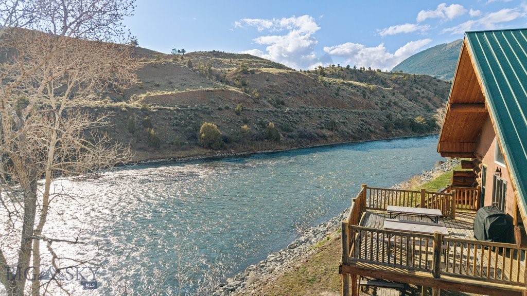 Gardiner Montana riverfront property. Overlooking the iconic Yellowstone River on 5.5 pristine acres, this exceptional property combines comfortable lodging, a sought-after event venue, and Montana's breathtaking natural beauty into one remarkable offering. With a proven history of successful bookings and a loyal base of returning guests, this is far more than real estate—it's an established hospitality business.
Rare opportunity to acquire a fully operating, turnkey vacation rental and wedding/event venue at the gateway to Yellowstone National Park's North Entrance. TWO large lodges and a commercial event venue combine an established short-term rental business with exceptional riverfront real estate. Offering immediate income potential in one of Montana's premier tourism destinations, the centerpiece is a timber-frame event barn completed in 2022, designed to host 100–150 guests and featuring a commercial kitchen, picture windows, loft, and patio. The riverside covered ceremony space and expansive patio showcase sweeping views extending into Yellowstone National Park, creating an unforgettable backdrop for weddings and events.

Two custom log homes provide 12 bedrooms and 7 bathrooms, comfortably sleeping 36 guests, with flexible rental options for one lodge, both lodges, or the entire property. The current owners have carefully curated this legacy property for decades. The main lodge tells a unique Montana story: in the early 1990s, the owner used his horse team, Duke and Dan, to harvest the massive logs from the hills across the river and hand-hewn them into the lodge. Today, those logs carry the rich patina only time can create.

The property hosts weddings, retreats, corporate gatherings, family reunions, and private events, creating multiple income streams. Guests enjoy Yellowstone National Park just minutes away, along with world-class fishing, floating, hiking, and wildlife viewing. Yellowstone Hot Springs is only 4 miles away, while Chico Hot Springs, Sage Lodge, and fine dining are within 30 minutes.
With no covenants, direct river frontage, established income, and hospitality infrastructure already in place, this is a unique investment opportunity in one of Montana's most iconic destinations. Whether you're seeking a strong-performing investment, premier event venue, destination retreat center, or legacy property, this Yellowstone River retreat delivers. Showings will need to work around booked guests. Please watch the video!