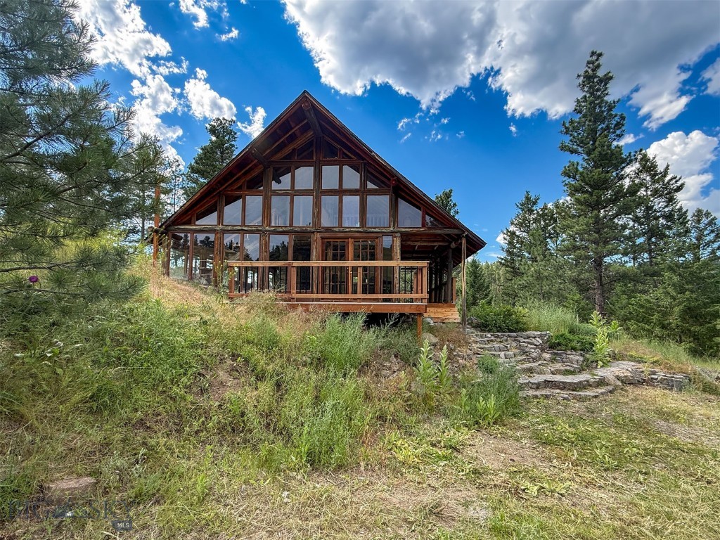 Come find a charming AND heavily upgraded AND remodeled log cabin with soaring ceilings, walls of windows, a custom stone fireplace and other stone features throughout the home and exterior. Take in mountain and territorial views from any of the 4 separate parcels equaling 106 acres! You