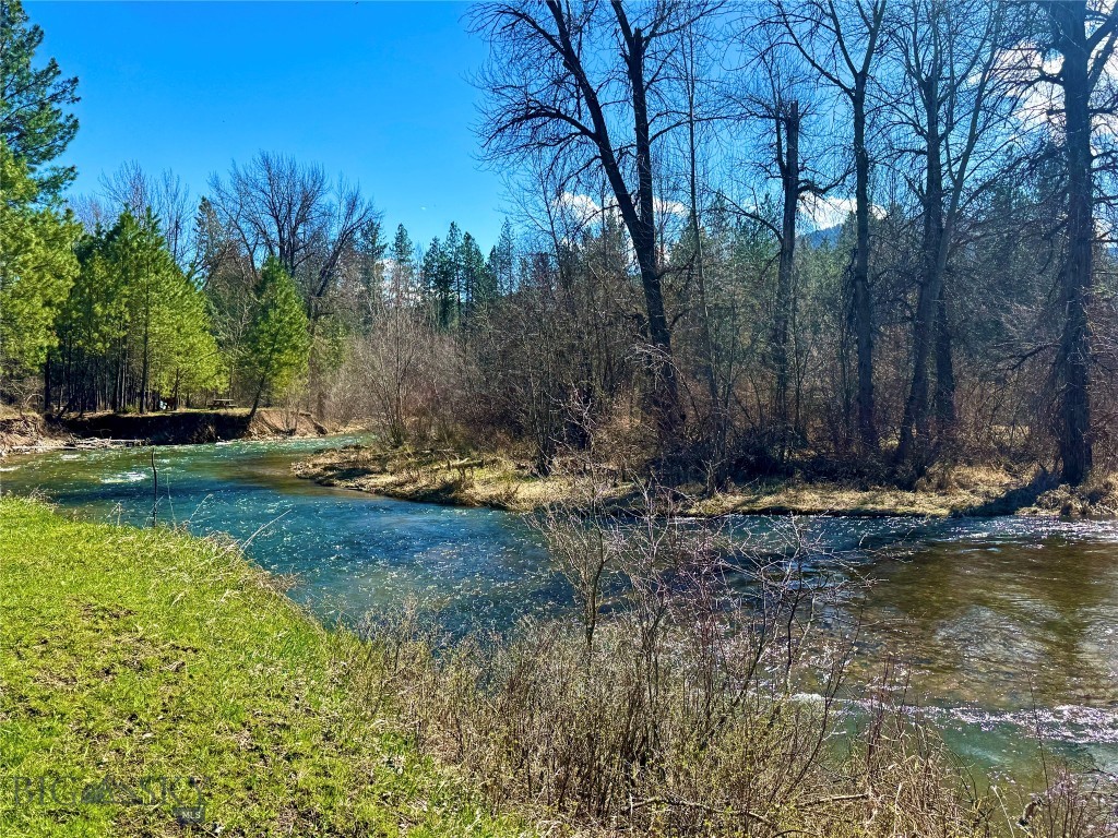 The crystal waters of Ninemile Creek serenade these 4.57 acres that stretch through the beautiful Ninemile Valley. The year-round water attracts abundant wildlife while drowning out the noisy sounds the bustling city. Multiple potential building sites are nestled throughout the property, providing the opportunity to design and build the Montana retreat you’ve always envisioned. With a productive well estimated at 3–5 GPM and a 1,200-gallon cistern already in place, essential infrastructure supports your plans while preserving the land’s untouched character. Outdoor recreation is right at your doorstep in this highly sought-after area, with convenient access to hiking, hunting, fishing, and expansive public lands. Despite its peaceful and secluded setting, the property is located just 22 miles from Missoula and its international airport, offering an ideal balance of quiet living and modern convenience. With opportunities to build, camp, or create a seasonal getaway, this property offers exceptional flexibility in a setting that makes it hard to ever leave.