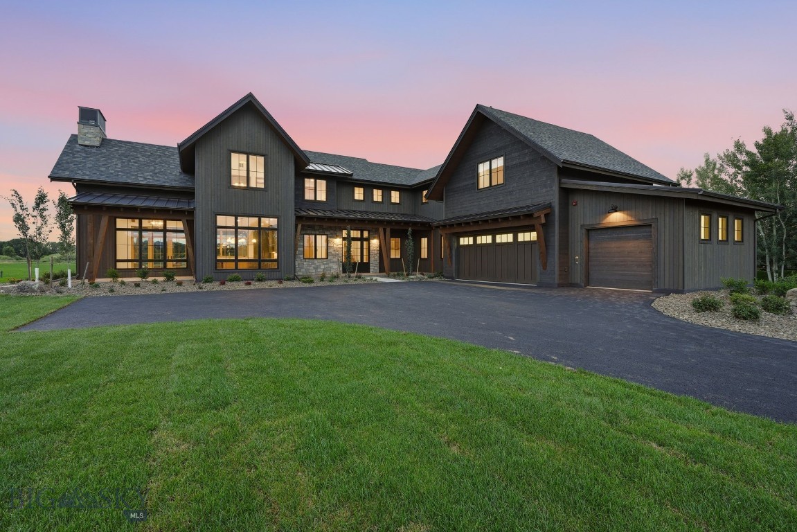 Welcome to 609 Tillyfour Road, an exceptional newly completed custom residence nestled within Bozeman's Black Bull Golf Community. Offering 4,207± sf of thoughtfully designed living space, a 823± sf heated three-car garage, and more than 830± sf of covered outdoor living, this 5 bed, 5.5 bath home blends exceptional craftsmanship with timeless luxury. Built with uncompromising quality, the home features fire-resistant wood siding, JELD-WEN Siteline windows, a four-zone natural gas HVAC system with dual A/C units, spray foam roof insulation, 10'4" main-level ceilings, engineered white oak hardwood flooring, solid alder doors and trim, designer lighting, Kohler fixtures, Emtek hardware, and fire suppression system. The chef's kitchen is centered around a custom furniture-style oak island topped with a stunning Leblon quartzite slab and surrounded by floor-to-ceiling custom cabinetry by local craftsman Terrian Designs. Mont Blanc quartzite countertops, an oversized Kohler farmhouse sink, smart faucet, pot filler, and a premium Thermador smart appliance suite create an exceptional culinary space. A fully equipped butler's pantry provides additional prep space, storage, and appliances. The light-filled great room features French doors opening to a covered patio, floor-to-ceiling masonry gas fireplace, custom built-ins, and a statement Arhaus chandelier. The main-level primary suite offers vaulted ceilings with exposed beams, private patio access, a cedar-lined walk-in closet, and a spa-inspired bath with heated floors, marble flooring, Spanish Zellige tile, a soaking tub, oversized shower, custom oak cabinetry, and Mont Blanc quartzite countertops. Upstairs each bedroom enjoys its own bathroom and includes a spacious junior primary suite, two additional guest suites, and a versatile 20' x 24' bonus room ideal as a 5th bedroom, family room, or fitness studio with mountain and open-space views. Outdoor living includes three covered stamped concrete patios, a natural gas fire pit, and professionally designed landscaping valued at more than $100,000 with a 12-zone irrigation system. Located on a quiet street in Black Bull, residents enjoy championship golf with golf membership, a resort-style pool, fitness center, clubhouse, dining, walking trails, and sweeping mountain views just minutes from downtown Bozeman. Thoughtfully designed and impeccably crafted, 609 Tillyfour Road offers an exceptional opportunity to experience luxury Montana living at its finest.