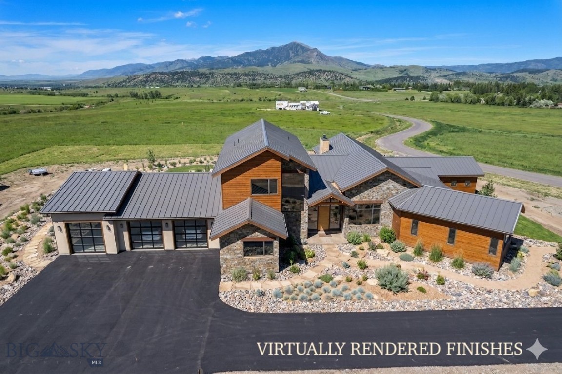 Set within the serene landscape of Sandhill Subdivision, 383 Boreal Way presents an extraordinary mountain contemporary residence just 5 minutes from downtown Bozeman. Positioned on 2.265 ±  acres with unobstructed Bridger Mountain views, this 4-bedroom, 4.5-bathroom home spans an impressive 5,775± square feet, blending refined luxury, thoughtful design, and top-tier efficiency. A stunning foyer with soaring cathedral ceilings creates a dramatic introduction upon entry, flowing seamlessly into the expansive great room, chef’s kitchen, and dining area. Framed by walls of triple-pane Bertrand windows, the primary living spaces and adjacent parlor capture breathtaking mountain vistas and abundant natural light. The open-hearth gas fireplace creates a striking barrier between the living room and parlor. The chef’s kitchen is complemented by a breakfast nook, spacious service pantry, and direct access to a dedicated media room wing, creating an ideal layout for both entertaining and everyday living. The main-level primary suite offers a private retreat with expansive views, an oversized walk-in closet, and a spa-inspired ensuite featuring a steam shower and soaking tub. Two additional main-floor bedrooms are thoughtfully positioned for privacy, each with its own ensuite bathroom, walk-in closets, and separation from neighboring spaces. Upstairs, the fourth bedroom is accompanied by a family room complete with a walkout deck overlooking the Bridger Range and the surrounding Bozeman area. The three-bay garage offers substantial additional space ideal for a home gym, storage, workshop, or recreational lounge. Built for both comfort and efficiency, the home features in-floor radiant heat throughout, interior rock wool insulation for sound dampening, a comprehensive rainwater catchment system, solar power capability, and premium triple-pane windows. The exterior showcases timeless cedar siding treated to sustain a 1-hour fire rating, natural stucco, and real stone walls, delivering a striking mountain contemporary aesthetic from the moment you arrive. Sandhill Subdivision offers a setting unlike any other in the Bozeman with a community building, trail systems, rolling terrain, and panoramic mountain views create a truly exceptional place to call home.