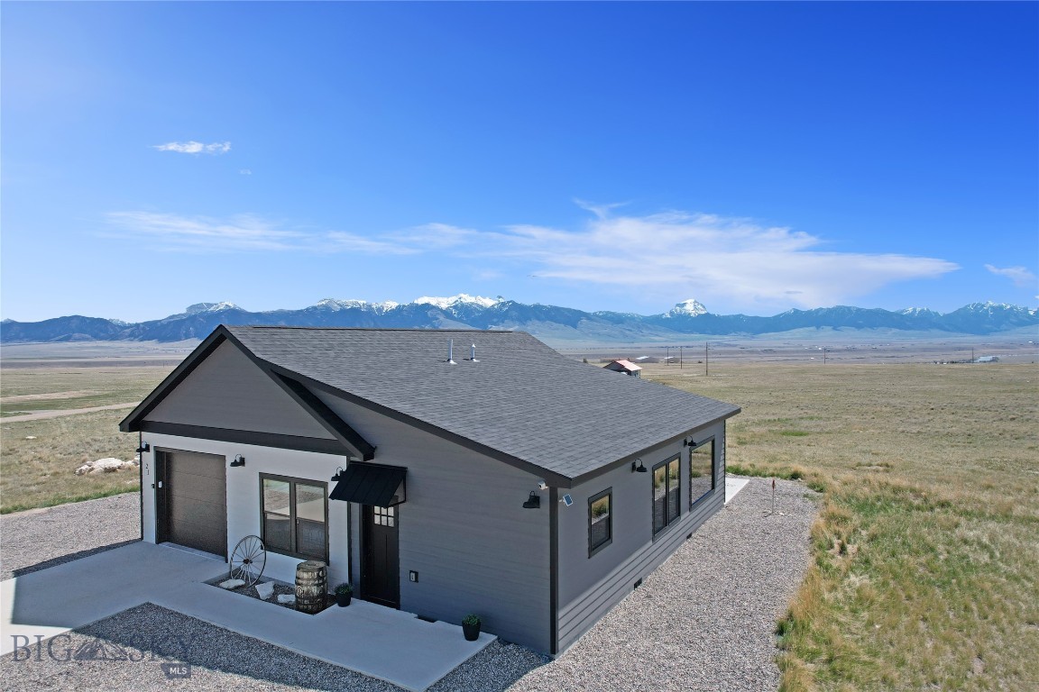 Turn-Key ready for your new home or use the added income potential as it is currently used as a short term rental.  3 bedrooms - 2 full baths - 9' walls and massive views of the Madison Mountains is this 1244 SF home located in the heart of the Gravelly Mountains and just a short distance to the Madison River.  The open floor plan (Living Room, Dining Area, and Kitchen is graced by 9' walls and large windows bringing the outside views in.  The kitchen has an abundance of cabinets, beautiful granite counter tops/back splash, and newer GE appliance package including range, refrigerator, dishwasher, and microwave hood). The main bedroom has an en-suite full bath (including double vanity and walk-in closet).  The second and third bedrooms, along with guests, have access to the second full bath.  Enjoy and evening of grilling on the eastern side patio or hit Haypress trout stocked lakes picnicking between casts.  The attached single car garage has extra storage and there are over 5 acres of land should you want to build more.  Hunting, hiking, horseback riding, or using the backroads to explore the mountains in your side by side, you will find a multitude of recreational opportunities.  There are lots of choices (to rent or not to rent) and tons of potential as you create options that are best for your lifestyle.  In Montana you don't just buy a property, you do purchase a new lifestyle!
