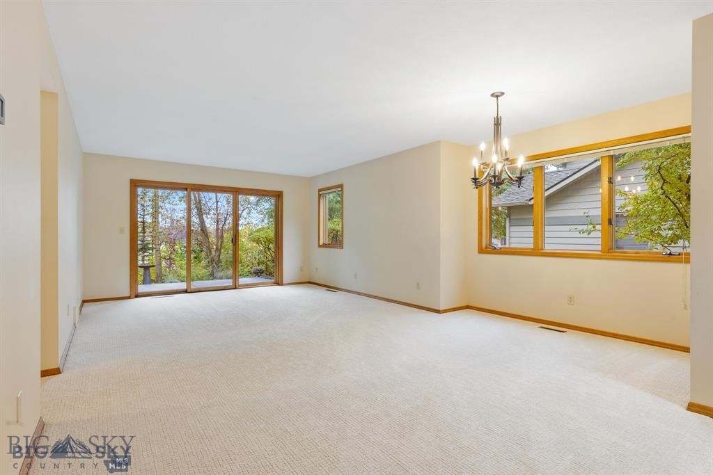 Discover comfort and convenience in this well-maintained 3-bedroom, 2-bath condo ideally located near MSU, downtown Bozeman, and all the best the area has to offer. Enjoy a view of Roskie Hall and the Brick Breeden Fieldhouse right from your doorstep, placing you in the heart of campus life and close to major events, sports, and entertainment. The open-concept living, dining, and kitchen areas create a welcoming flow with excellent separation between bedrooms. A spacious main-level bedroom and full bath offer flexibility, while two additional bedrooms and a second full bath upstairs provide space for guests, roommates, or a home office. Step outside to a private patio surrounded by mature trees, perfect for relaxing or entertaining. An attached garage offers secure off-street parking and extra storage. Freshly painted with new carpet on the main level and move-in ready, this centrally located, low-maintenance home presents an exceptional opportunity to enjoy Bozeman living at its best.