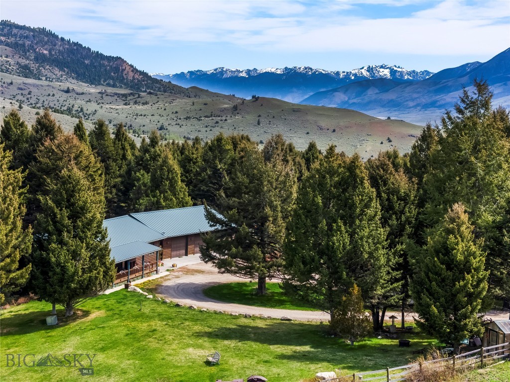 Would you like to escape to your own private Montana retreat where mountain serenity meets year-round adventure? Nestled on 20 breathtaking acres of aspens, pine trees, and open meadows, this exceptional property offers unmatched privacy, stunning sunset views of the Gallatin Divide, and quick access to some of the West's finest outdoor recreation.
Just 25 minutes from Gardiner, the iconic northern entrance to Yellowstone National Park, and only 45 minutes to Livingston, this property delivers the perfect balance of seclusion and convenience. A nearby Forest Service trailhead opens access to thousands of acres of public land, offering endless opportunities for hiking, horseback riding, hunting, fishing, and wildlife viewing. Ride your horse directly to Forest Service land across the road or venture five miles to the Rock Creek Trailhead within the Gallatin National Forest.
Wildlife is abundant here. Deer, elk, the occasional moose, and a plethora of bird species regularly visit the property. Just a short hike away, Rock Creek offers a fishing option adding to the peaceful, retreat-like atmosphere. The Yellowstone River is only 12 minutes away, and Highway 89 is an easy 15-minute drive.
The property is fenced and horse-ready, making it ideal for equestrian enthusiasts or anyone seeking a true Montana ranch lifestyle. 
The well-maintained 2,688 sq. ft. home built in 1998 features 3 bedrooms and 2 bathrooms with warm, comfortable living spaces designed for all seasons. Enjoy radiant in-floor heat from the gas hot water boiler system as well as a cozy gas stove in the great room. A large covered wraparound porch overlooks the beautifully irrigated lawn and captures unforgettable western sunsets.
Also included is an impressive 1,768 sq. ft. heated 3-car garage/shop complete with its own bathroom, perfect for equipment, toys, projects, or additional workspace.
Whether you’re looking for a full-time residence, recreational basecamp, horse property, or private mountain getaway, this extraordinary property embodies the very best of Montana living.
