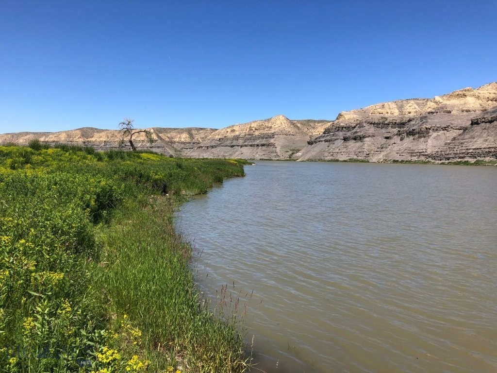 Missouri River frontage with fishing, boating, hunting, and power, with BLM land across the river out in the country between Great Falls, Montana, and Fort Benton, Montana. Land in Montana on the banks of the Missouri River isn’t easy to come by. This is your chance to own Missouri River frontage out in the countryside of Montana. It bears repeating: this property has Missouri River frontage. This amazing Montana property borders the Missouri River for 333 feet and gives you approximately 10 acres of land you could build your Montana cabin or home on. You’ll have the mighty Missouri River right out your front door to see, hear, and go fishing or boating on any time you want. The Missouri River is renowned for its trout, walleye, and pike fishing, as well as smallmouth bass, carp and catfish. By owning river frontage, you’ll have easy access to the river to enjoy day in and day out. Just step out the front door of your cabin with your fishing pole in hand and take to the river for relaxation and fun as you catch the big ones in the waters of the Mighty Mo (Missouri). There are geese, ducks, and other waterfowl as well as bald and golden eagles that all use this stretch of the Missouri River for the valuable food and water it provides. The eagles can be seen gliding along the banks of the Missouri River, looking for food, or soaring along the bluffs on the opposite bank, making it seem effortless to look down on everything from above. The deer and antelope in the area also use the river for the valuable water and nourishment it provides. That is evidenced by the trails you can see on the bluffs across the river on the BLM land there. You can watch them from the cabin on your property, and during hunting season, you can hunt that BLM land that borders your land just across the river. In fact, they’ll be within range during the general hunting season as they come down to water at the river. Just wait and watch them from your picture windows. And if that’s not enough, the access road leading to the property goes through BLM land you can hunt and hike on too. There’s plenty of other BLM and State lands in the area in addition to that, as well as block management areas that are open to hunting on private lands. The area is also well known for its fantastic pheasant and upland game bird hunting. You’ll see ring-necked pheasants and other game birds just standing along the roads leading to your property on the Missouri. You can’t go wrong with this one.