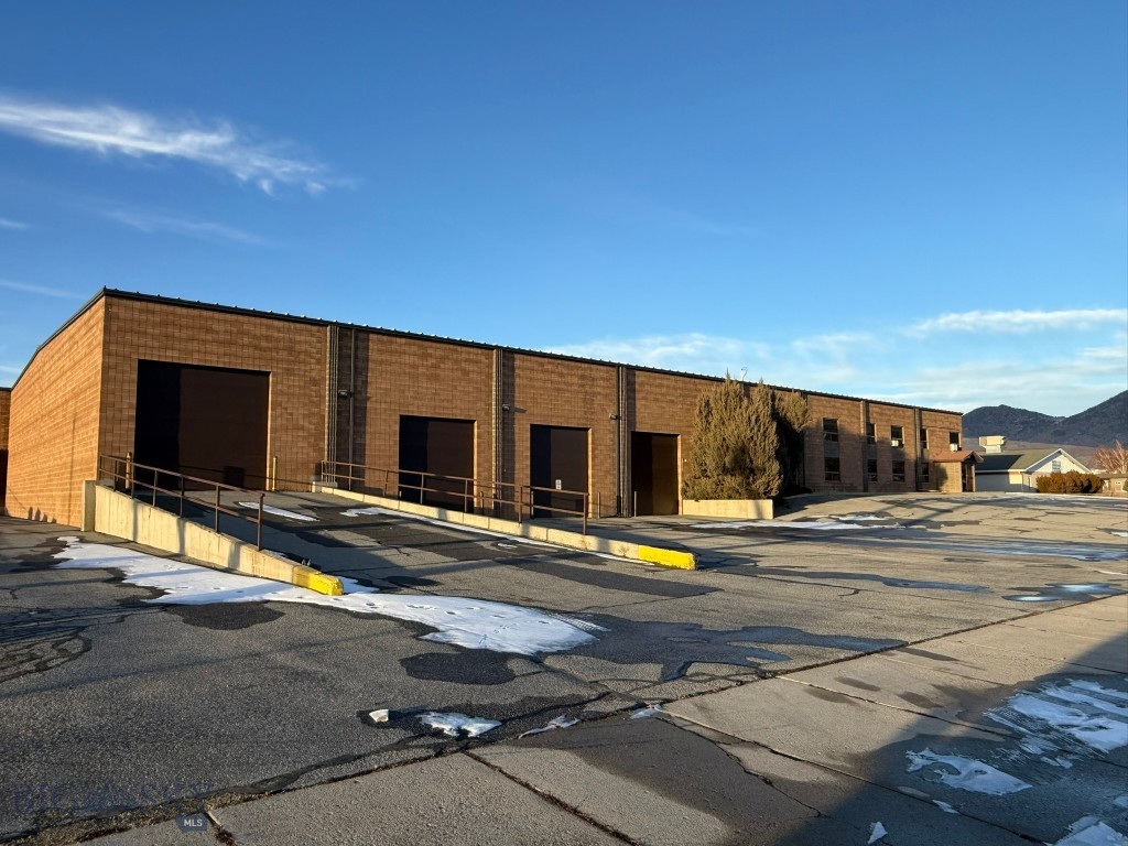 This large industrial warehouse is centrally located in the Butte Warehouse District, originally constructed in 1990 for a beer and wine distribution business. The facility features durable cement block construction, complemented by a metal roof and steel truss system. Office spaces are equipped with hot water heating, while both the warehouse and offices benefit from heating and air conditioning systems.
The warehouse encompasses approximately 20,368 square feet, with an adjoining office area of roughly 7,840 square feet. Key amenities include two semi loading docks, three industrial overhead doors, and one bay door with a drive-in ramp for direct warehouse access. The property boasts approximately 20-foot ceilings, a cooler, substantial storage capacity, and a two-story office suite comprising a spacious reception area, walk-in safe, five main-floor offices, executive offices on the upper level, a large conference room, and three restrooms—two of which have showers. The property is owned by the listing Broker.
Additional features include four separate exits, parking accommodations for 27 vehicles with supplementary space available in the yard, and three-phase electrical service. This property is currently owned by the listing broker.