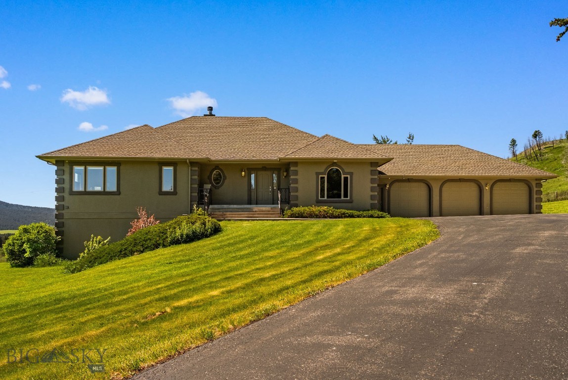 Tucked into the heart of Bridger Canyon, this just-over-four-acre property offers sweeping mountain views in every direction and the space to enjoy a true Montana lifestyle. Wide-open skies, peaceful surroundings, and usable acreage create a setting that feels both private and connected—all just 15 minutes from Bozeman, about 10 minutes to Bridger Bowl Ski Area, and only 8 minutes to Crosscut Mountain Sports Center for cross-country skiing in the winter and mountain biking in the summer. The land provides flexibility for a variety of uses, with room to create your ideal setup—whether that includes space for horses, outdoor living, or simply enjoying the open landscape. It’s a rare combination of privacy, views, and acreage paired with immediate access to some of the area’s best year-round recreation. Inside, the home is spacious and comfortable, with generously sized bedrooms that give everyone room to spread out. The main-level primary suite features a beautifully renovated en suite bathroom that feels fresh and refined. Two wood-burning fireplaces add warmth, ambiance, and classic Montana character. The walk-out lower level adds versatility with space for an additional bedroom, bonus room, home gym, office, or private guest quarters. A three-car garage offers ample room for vehicles, gear, and storage. Private acreage, sweeping views, and access to Bridger Canyon’s outdoor lifestyle—this is Montana mountain living at its best!