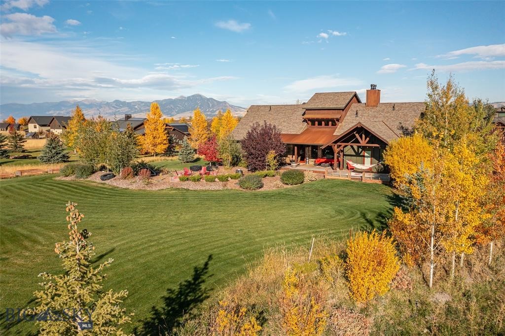 Welcome to this stunning 6-bedroom, 5.5-bathroom custom-built home offering 6,393 square feet of thoughtfully crafted living space, built in 2014. The home combines rustic charm and modern elegance, with hand-picked finishes and reclaimed wood from the 100-year-old local farm. Upon entering, you’re greeted by the custom rock wall framing expansive windows, setting the tone for the home’s craftsmanship. The chef’s kitchen is designed for both function and style, with a hidden butler’s pantry that keeps the space clutter-free, perfect for hosting and daily use. The oversized fireplace is one of the home’s standout features, transforming the space into a cozy mountain retreat. Just off the main living area, the main-level master suite features a luxurious en suite bathroom. Two additional bedrooms on this level offer flexible living options, including one suite ideal for guests, extended family, or as a private retreat. Filled with natural light and wide-open views, the home creates a seamless connection between indoor and outdoor living, offering a tranquil space for nature lovers. The basement includes a private gym area, perfect for staying active year-round in the comfort of your own home. In addition, the basement offers abundant flex space that can be customized to suit your needs, whether as a playroom, media room, or home office. Set on over an acre with mature landscaping, the property offers privacy and beauty while still being conveniently close to everything. The versatile bonus room can serve as a nanny suite or private in-law apartment, complete with its own bedroom, 3/4 bath, and kitchenette. Step outside to a massive covered back deck that expands your living space and invites year-round enjoyment. Built with energy-efficient insulated concrete form (ICF) walls—13” thick in the basement and 11” above grade—the home provides year-round comfort, minimal wind infiltration, and durability. The oversized 3-car attached garage offers ample space for vehicles, gear, and hobbies, while abundant storage throughout the home keeps everything organized. This home is a rare blend of heart, functionality, and enduring style.
