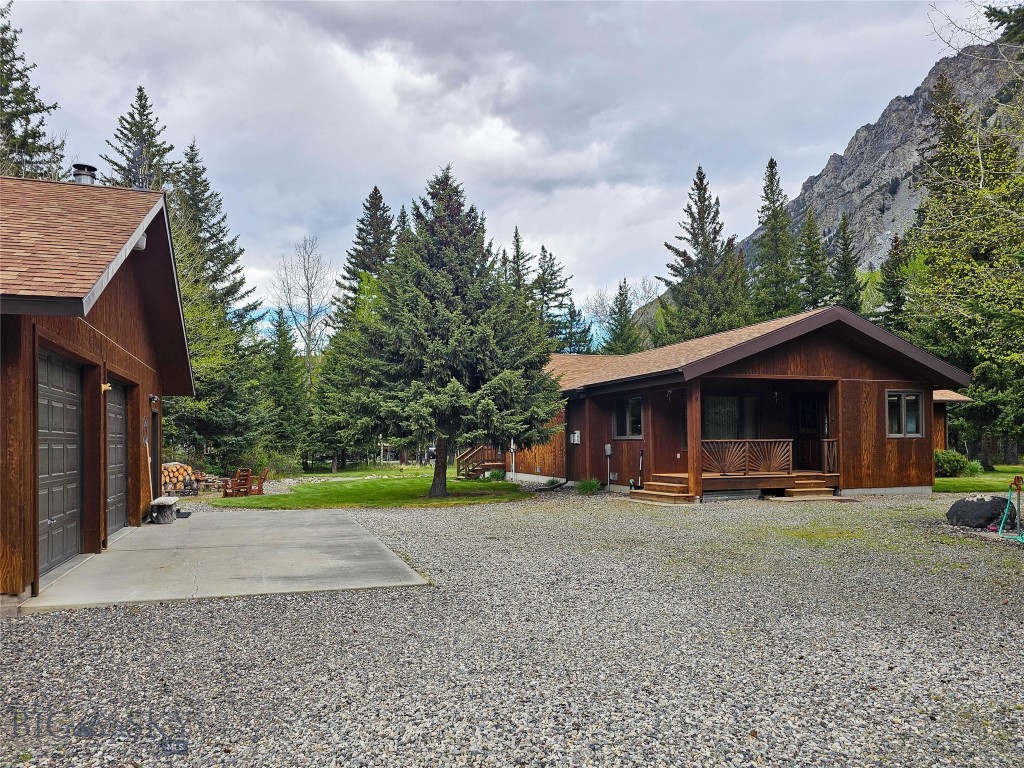 Nestled among the pines in a peaceful mountain setting, this immaculate cedar-sided home offers the perfect Montana retreat just steps from the National Forest Service and the renowned Boulder River. Whether you are looking for a cozy family cabin or comfortable year-round living, this turnkey property is ready to enjoy from day one.

The charming 3-bedroom, 1-bath main home features warm rustic touches throughout, including a stunning river rock gas fireplace and an additional gas stove for added comfort. Heated tile floors in both the kitchen and bath create a welcoming touch during every season. The inviting screened-in porch with a built-in BBQ is the ideal place to relax, entertain, and take in the tranquil surroundings.

Outside, the lush lawn is maintained with underground sprinklers, while the detached three-car garage and separate shop provide ample space for vehicles, storage, and hobbies.

Guests and family will appreciate the separate apartment offering 2 bedrooms, 1 1/2 bath, a kitchenette, and a covered deck perfectly positioned for enjoying mountain views and abundant wildlife, including frequent moose sightings. The guest apartment is handicapped accessible.

Located just 45 minutes south of Big Timber, Montana, this exceptional property combines seclusion and convenience, with both Billings and Bozeman airports within a two-hour drive. A rare opportunity to own a private mountain getaway with recreation, fishing, hiking, and nature right outside your door.