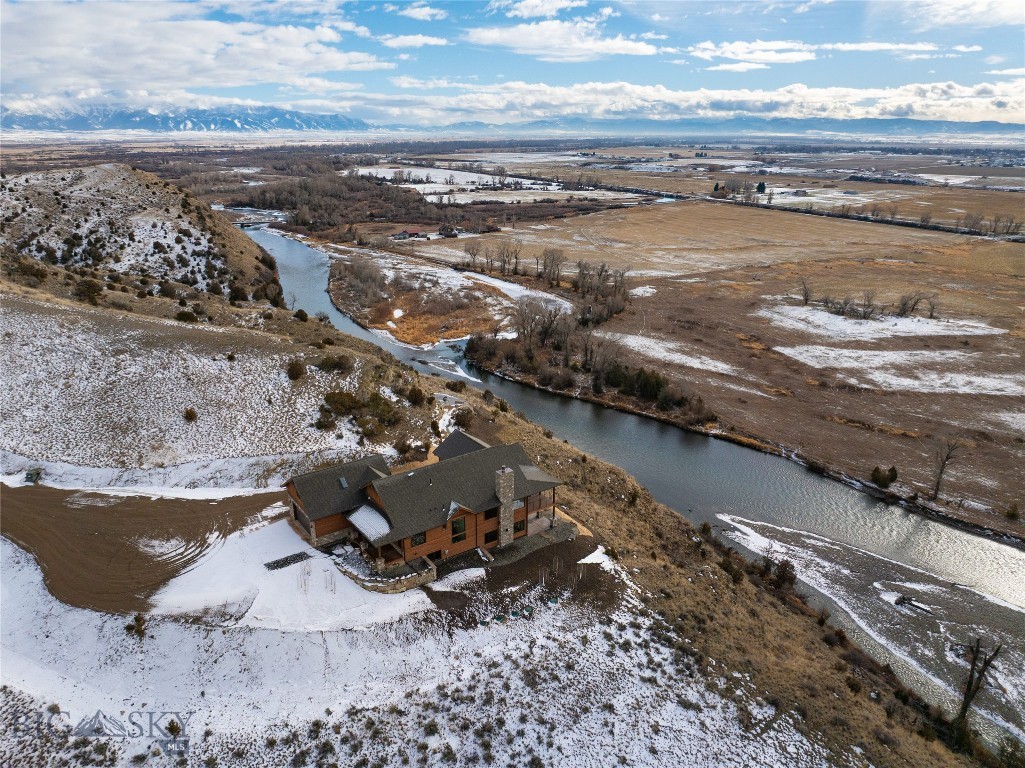 Riverfront luxury in Gallatin River Ranch. This newly constructed 4,500sq ft residence sits on 20+/- acres with approximately 660 feet of Gallatin River frontage. The setting offers some of the most incredible and expansive views in Gallatin County. Enjoy sitting on from the covered deck, overlooking the river and enjoying the scenery and wildlife, including a resident elk herd. Designed and built by Vidmar Construction, the 3 bedroom, 3.5 bath home features vaulted ceilings, luxury vinyl plank flooring, Thermador appliances, an oversized island, formal dining room, butler’s pantry, bonus room over the garage and a wine room. Both propane and wood-burning stone fireplaces add warmth and architectural interest. Large windows throughout the home are thoughtfully placed to capture river and mountain views from nearly every room. The oversized primary suite has two walk in closets, a large en suite bathroom, fireplace and it's own generously sized private patio looking out over the river. Outdoor features include over $200,000 in professional landscaping, a covered Trex-style deck, and a propane fire pit, ideal for enjoying the natural surroundings. Additional amenities include a heated garage, Kohler backup generator, 1,000-gallon underground propane tank, Starlink internet, Unifi security cameras and Wi-Fi access points, water softener and reverse osmosis system. Ability to build a second home on the property with plans available for a larger residence. This is a rare opportunity to own a newly built riverfront property in one of Montana’s most sought after communities.