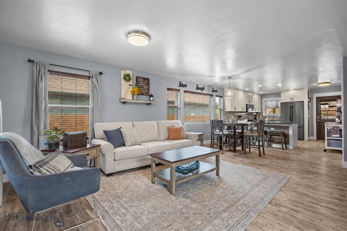 Step into this spacious, open-concept home featuring a bright living, dining, and kitchen area filled with natural light, warm modern tones, and custom lighting throughout. The main level offers a newly remodeled kitchen, spacious pantry, custom blinds, and convenient laundry with an updated powder room. Large windows and southern exposure create an inviting, sun-filled atmosphere.

Upstairs, you’ll find three additional bedrooms - one that could make an ideal secondary living area, home office, playroom, or media space - a full bathroom, and a generous primary suite complete with a walk-in closet and private ensuite featuring a custom tiled shower.

Enjoy outdoor living with a large covered front porch and an expansive covered back deck—perfect for relaxing or entertaining. The oversized attached garage includes workbenches and plenty of storage space.

Located on a quiet street in the desirable River Rock community, residents enjoy access to an elementary school, scenic pond, walking trails, and nearby shopping.
