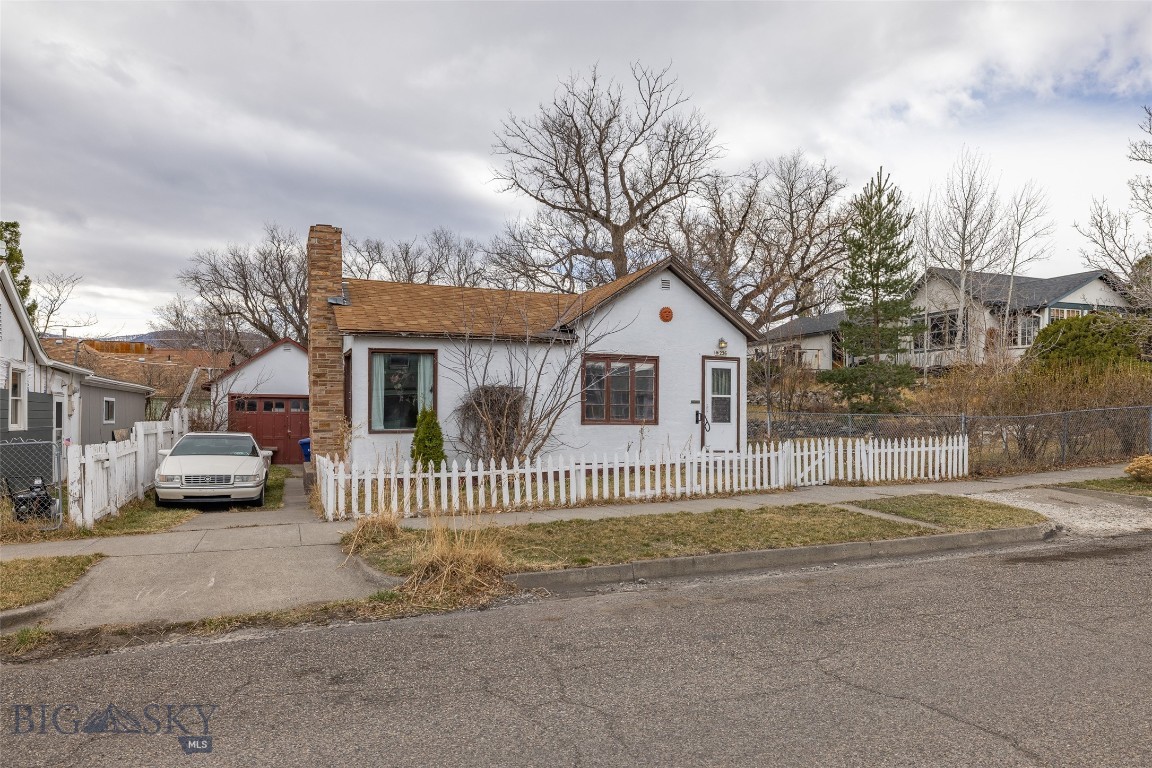 This charming 2-bedroom, 1-bath home is located in Livingston's south side, walking distance to everything. Fully fenced yard and 1 car detached garage. One bedroom on the main level and one bedroom in the lower level. The home offers a bright kitchen space with access to the small back porch that leads to the tree lined fenced backyard.
One full bath on the main level just off the kitchen. The open living room and dining space feature a gas forced air heater and a wood fireplace.  The property is being sold as is, does need a new roof and the seller is prepared to offer a $10k credit towards the roof. Bring your creative self and bring this property back to its former glory or move right in and enjoy this in town location. Laundry room in the lower level with washer and dryer.