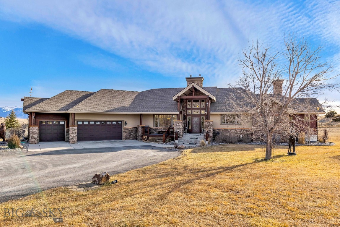 This exceptional custom Montana luxury residence is a blend of timeless craftsmanship,
thoughtful design, and elevated living. Set on 20.2 acres of unobstructed views, the home is
perfectly positioned on one of the premier lots within the subdivision, offering privacy, space,
and sweeping vistas in every direction.
The interior showcases rich natural materials throughout, including copper trim, warm wood
and log accents, and a dramatic stacked stone fireplace that serves as the focal point of the
living room. A pine tongue-and-groove ceiling enhances the authentic character,
creating an inviting atmosphere. The kitchen is anchored by beautifully crafted
alder and hickory cabinetry, granite countertops, and a beautifully designed custom stone cooking area that blends functionality with striking visual appeal. Pella wood-clad tinted windows frame the surrounding landscape
while offering energy efficiency and year-round comfort, bringing the beauty of Montana
indoors.
Outdoor living is a true highlight, featuring an impressive three-tier deck ideal for hosting
gatherings, or simply taking in the uninterrupted views.
Beautifully designed landscaping enhances the setting, blending naturally with the surrounding
terrain and adding to the home’s curb appeal.
The lower-level family room extends the home’s entertainment options, featuring a wet bar and
direct access to a deck with creating an ideal space for gatherings, recreation, or relaxed evenings with friends and family. The primary suite offers a private sanctuary with a spa-like bath, private fireplace, access to a
private deck while additional bedrooms and living areas provide
flexibility for guests, work, or recreation—all finished to the same uncompromising standard.
The property is further complemented by a spacious heated three-car garage, offering ample
room for vehicles, storage, and recreational gear—perfectly suited for Montana living.
Beyond the home, residents enjoy access to over 1,600 acres of common area easements,
providing extensive hiking and riding trails, East Gallatin River access, and a fully equipped
equestrian center designed for both horse and rider. As part of GRR, ownership includes access to: walk-out Gallatin River frontage, 640 acres of State Land & 270 acres of Fish & Wildlife land. 
A rare opportunity to own a truly custom Montana luxury home where craftsmanship, acreage,
mountain views, and premier community amenities come together seamlessly.