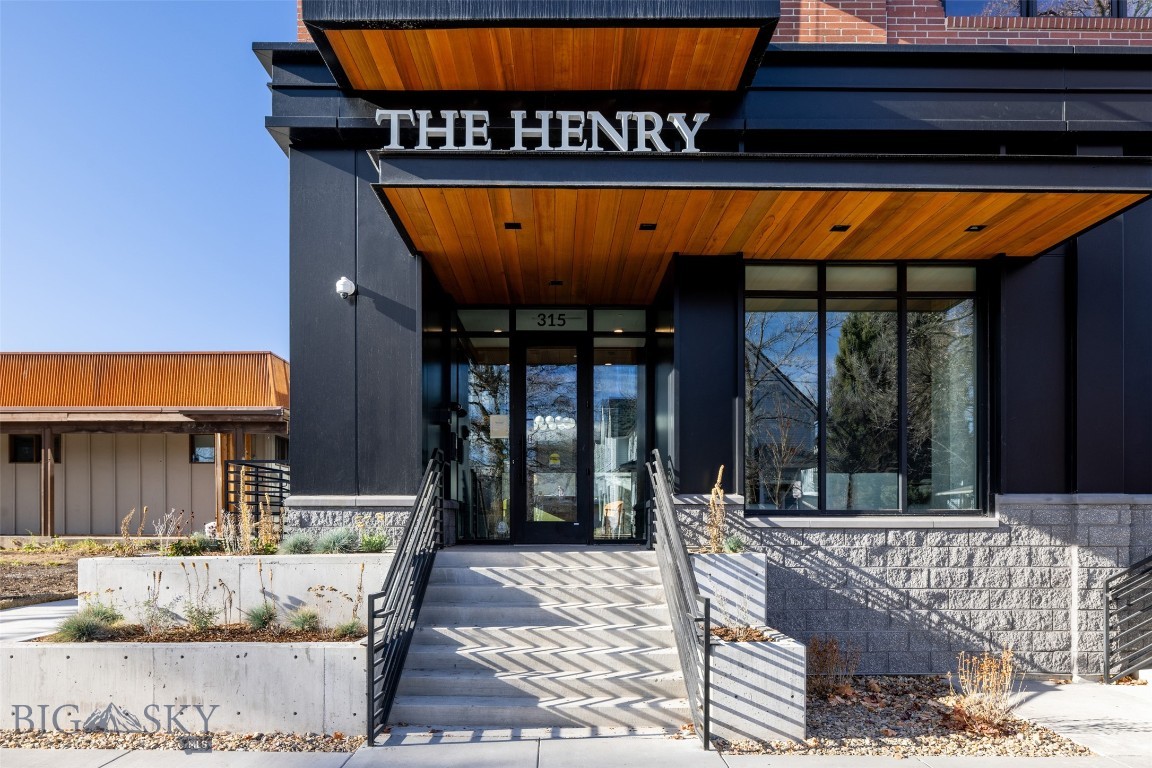 A truly rare offering in downtown Bozeman, a luxury penthouse with unobstructed, framed views of the Bridger Mountains from every room. This one-of-a-kind residence is intentionally designed so the mountains become the focal point, with the living area and primary suite perfectly oriented to capture the dramatic skyline.
Experience elevated living in this 2,011 SF new-construction penthouse, where expansive windows, abundant natural light, and an open, refined floor plan create an effortless sense of space. Ideally situated in the heart of downtown, you’re just steps from Bozeman’s best dining, shopping, and cultural amenities. The gourmet kitchen is outfitted with Thermador appliances, a wine fridge, and a striking waterfall island, ideal for cooking, gathering, and entertaining. With 2 bedrooms and 2.5 baths, all ensuite, plus a generous den/office, the home blends comfort, privacy, and versatility. Enjoy the 273 SF heated, covered patio boasting those amazing views, for year-round outdoor enjoyment. Practical luxuries abound, including pre-wiring for electric shades, designated storage and heated underground parking with EV-ready wiring. The secure, amenity-rich building offers outdoor common spaces, a fully equipped gym, bike storage, two conference rooms, and a dedicated mail room with cold storage for food deliveries.
