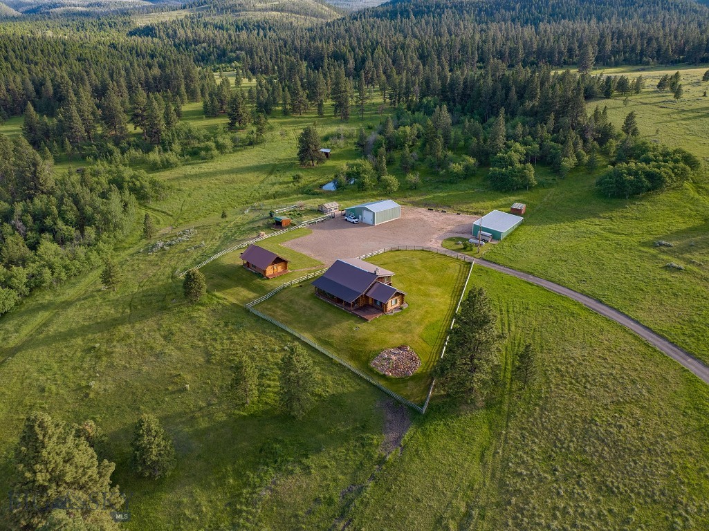 Perched on an elevated ridge overlooking the Nevada Creek Valley sits Mile High Ranch, a four-season recreational retreat in the midst of some of Montana’s wildest landscapes. The ranch offers privacy and room to explore, yet, at just under 170 acres, it is manageable with all the amenities those looking for a rural escape could want. The property is ideally improved with a 4,456+/- square foot, remodeled two-bedroom log home with two additional rooms which could be converted into bedrooms as well as an unfinished basement allowing for supplemental living or storage space.  Additional improvements include a fully appointed guest cabin, heated shop, equipment shed, and garden space with greenhouse. The property is gated, fully perimeter and cross-fenced into four pastures, and adjoins state ground, which in turn provides access to the 11,380-acre Hoodoo Mountain Wilderness Study Area.  Elk, deer, moose, and bear are frequent visitors.  Equipment and home furnishing package available for purchase making this a truly turnkey opportunity.