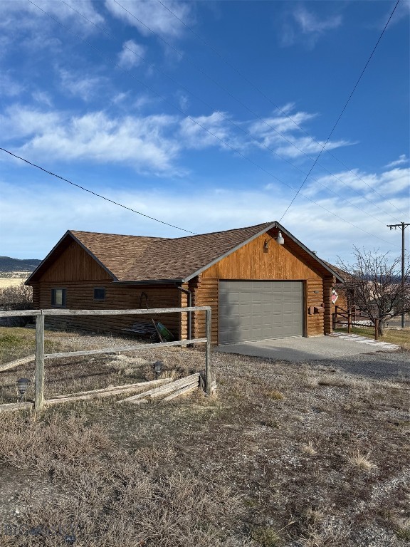 This home checks all the boxes for a dream property!  A log cabin with views of the Park Hills and a pond and located at the edge of town.  The open kitchen/dining/living room is inviting with vaulted ceilings and wrap-around deck.  The extra large bedroom has its own heat source, bath, and laundry area.  An attached 2-car garage with work bench, extra parking area, and underground sprinkler system are amenities.