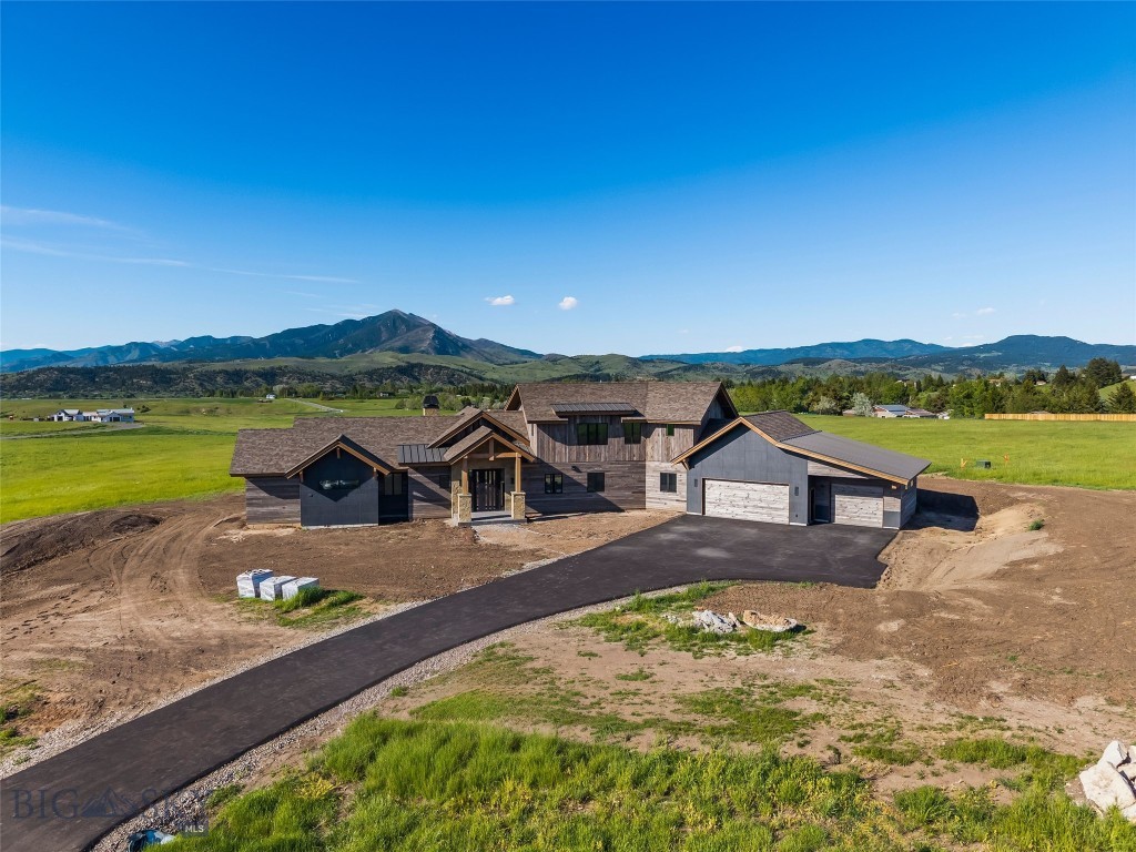 Welcome to 498 Boreal, an exceptional property located in the highly sought-after Sandhill subdivision, offering luxury living, incredible amenities, and breathtaking mountain views in every direction. Situated on 2.4 acres, this stunning home combines privacy, space, and access to one of Bozeman’s premier lifestyle communities.

Residents of Sandhill enjoy an unmatched amenity package including a beautifully designed community center featuring pickleball and basketball courts, a putting green, children’s play area, expansive outdoor fire pits and gathering spaces, a private barn and covered pavilion for events, and an owners’ lounge. Extensive trail systems weave throughout the community and connect directly to the Main Street to the Mountains Trail, providing convenient access all the way into downtown Bozeman.

The home itself is thoughtfully designed with 4 bedrooms, 4.5 bathrooms, and exceptional entertaining spaces throughout. The main level features a spacious primary suite, a guest bedroom with ensuite bath, a dedicated office, and striking glass-encased wine storage that serves as a stunning focal point. The open-concept living spaces are filled with natural light and framed by panoramic mountain views.

Upstairs, you’ll find two additional ensuite bedrooms along with a large secondary living and recreation room complete with a bar area, creating the perfect space for entertaining, relaxing, or hosting guests.

This home is being offered fully furnished with an upscale furniture package, allowing for a seamless, turnkey opportunity with carefully curated pieces that perfectly complement the home’s luxury design and mountain-modern aesthetic.

With luxury finishes, expansive views, incredible community amenities, and direct access to trails and recreation, 498 Boreal offers an unparalleled Bozeman lifestyle.