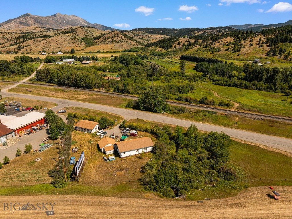 Discover opportunity just outside Bozeman, Montana. Perfectly situated between I-90 and the Frontage Road, this property offers unbeatable visibility and exposure for your business. With three existing structures on site, the property lends itself to a complete renovation or a fresh start with new construction - making it an ideal canvas for your vision. Enjoy stunning mountain views in every direction and the added charm of a creek running through the land. Whether you’re looking to redevelop or reimagine, this location combines natural beauty with prime accessibility.