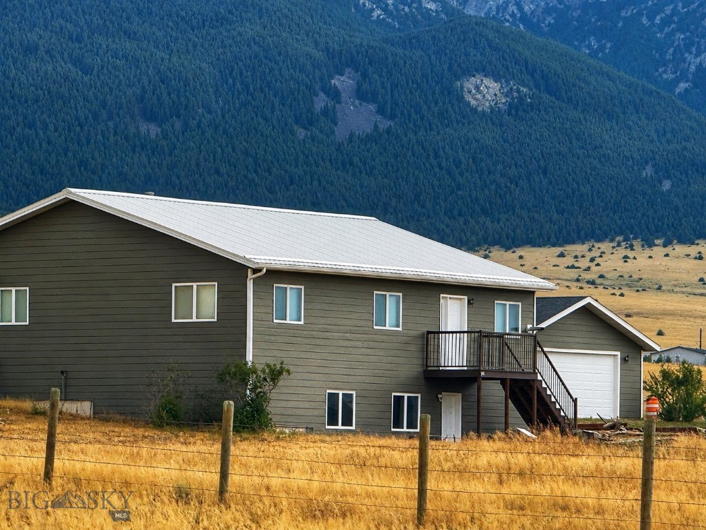Welcome to your Montana dream property nestled at the edge of the Boulder Mountains, where comfort, versatility, and country living come together on just over 32 breathtaking acres. This spacious home offers 3 bedrooms and 2.5 baths on the main level, featuring warm and inviting living spaces, a cozy fireplace, radiant heated floors, and a bright sunroom perfect for taking in the surrounding scenery year-round. Every window captures stunning mountain views, bringing the beauty of Montana indoors. Downstairs, a separate 2-bedroom, 1-bath living area provides incredible flexibility for rental income, guests, multigenerational living, or private accommodations. Thoughtfully updated, the home features newer interior and exterior paint, newer appliances, Trex decking, and multiple heat sources including a pellet stove, gas boiler, and electric heat for year-round comfort. After a day outdoors, relax in the hot tub or unwind in the infrared and steam sauna. Perfectly set up for horses and livestock, the property includes cross fencing, multiple pens with automatic waterers, a large corral system, chicken coop, and a beautiful newer barn completed in 2025 with loafing area and picturesque views. A spacious detached garage offers abundant room for vehicles, equipment, toys, or workshop space. With usable acreage, endless possibilities, and exceptional setup for both recreation and ranch living, this remarkable property captures the very best of Montana living.