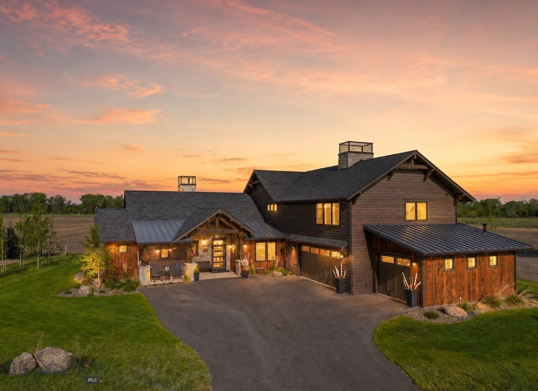 Experience privacy and some of the finest club amenities in the Black Bull Golf Club and Community in this luxury residence by ST Custom Homes. This 4-bedroom 3.5-bathroom home borders farmland offering unobstructed mountain views of the Gallatin Valley. The primary suite located on the main level has a spa inspired ensuite bathroom with heated floors, a deep soaking tub and massive shower with multiple heads. Enjoy direct access to your back patio and gas fireplace via large sliding doors. Soaring ceilings accented with reclaimed barnwood and a floor-to-ceiling tiled gas fireplace anchor the open-concept living space. The chef’s kitchen features a premium Thermador suite of appliances, modern integrated cabinetry, and sleek quartz surfaces, complemented by a dedicated wet bar and wine cooler for effortless entertaining. The two additional bedrooms connected by a Jack-and-Jill bath, a private home office, and a functional mudroom/laundry hub complete the main level. Upper Level offers a versatile bonus wing featuring a fitness space, a large media area, and a private guest suite with a full bath. The heated 3 car garage demands attention with 1,100 square feet, perfect for all your Montana toys. Attached to the garage is an exterior dog run with a dog door installed. As a resident of Black Bull, you’ll have access to a world-class Tom Weiskopf-designed golf course, a private clubhouse, a fitness center, and a pool, all just minutes from the heart of Bozeman.