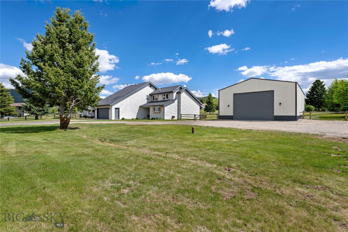 Charming modern farmhouse situated on 1 beautifully landscaped acre in the highly sought-after Warne Heights Subdivision. This exceptional 4-bedroom, 2.5-bath home offers an attached 2-car garage, a newly built 30’ x 45’ shop, and the perfect blend of comfort, functionality, and modern updates.  A grand foyer and stunning staircase create an impressive first impression, leading into the spacious floor plan designed for both everyday living and entertaining. The living room features abundant natural light, soaring ceilings, and a cozy wood-burning fireplace, while the formal dining room offers deck access and beautiful views. The updated kitchen features butcher block countertops, white cabinetry, subway tile backsplash, pendant lighting, a spacious peninsula with bar seating, pantry, and breakfast nook area. The main-floor primary suite provides a private retreat with double sinks, a walk-in shower, soaking tub, and generous closet space. A convenient half bath and laundry/mud room complete the main level.  Upstairs, you’ll find three additional bedrooms, a full bathroom, and a versatile loft/ office space.  Thoughtful updates include smart switches and ceiling fans, reverse osmosis and water softener system, along with a new high-efficiency boiler and hot water heater. Outside, enjoy the beautifully maintained yard with mature landscaping, underground sprinklers, partial fencing, RV parking with 30-amp outlet, and plenty of room to relax, play, or entertain. Ideally situated near public lands and endless recreation, Thompson Park Recreation Area is less than a mile away, offering quick access to hiking and mountain biking trails. The expansive Deer Lodge National Forest is also nearby, providing opportunities for hunting, fishing, camping, and year-round outdoor adventure. Surrounded by breathtaking mountain views and peaceful rural scenery, this exceptional property offers the perfect rural setting, outdoor recreation, and convenient access to city amenities.