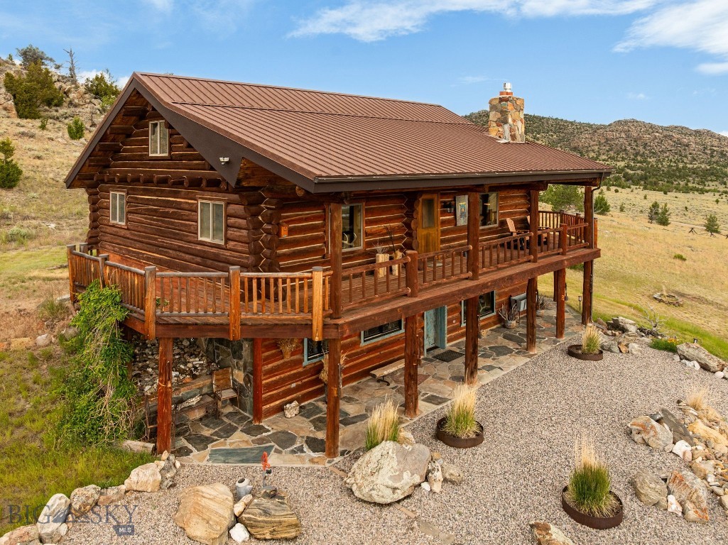 Rare opportunity overlooking Ennis, Ennis lake, and the Madison Range! This incredible 4+br, 3ba home is on 5 acres with a 40x50 shop, and has NO COVENANTS! This property offers privacy (unique for the area), amazing views, room for everyone, no-one  telling you what you can and cannot do, and is only a couple short minutes from the amenities of Ennis. 
 A thoughtfully landscaped outdoor patio with a walking path to a gorgeous propane fire pit sets the scene for evenings under the Big Sky, enjoying the views in the peace and quiet of this getaway. There is a large 40x50 metal shop (with 220V) to store all of those toys and equipment, or enjoy as a workspace. Each bedroom on the 2nd floor has it's own private entrance, there is a family room with high vaulted ceilings, and lets not forget that loft!!