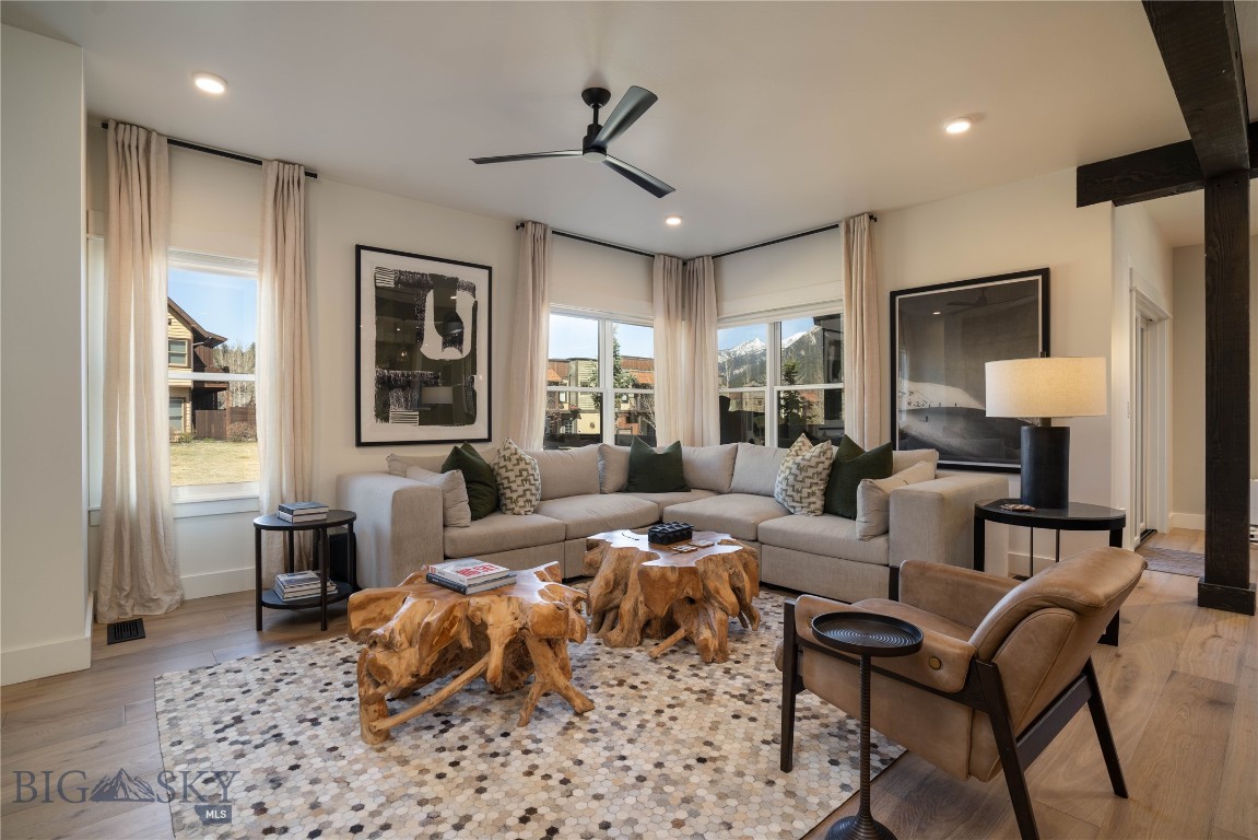 Rooted in the heart of Big Sky's Town Center and framed by the Montana mountains, this four-bedroom residence at 45 Degrees North represents the finest floor plan in the development. Spanning 3,686 square feet across three thoughtfully designed levels, the home has been recently updated with elevated finishes and furnishings throughout, along with central air conditioning and primary floor humidification for year-round comfort. The result is a turnkey retreat of uncommon quality in one of the Rocky Mountain West's most coveted destinations.
The main level welcomes with an open-concept chef's kitchen, dining area, and living room anchored by a gas fireplace. Covered outdoor patios extend the living space into the mountain air, where views of the surrounding peaks provide a constant and breathtaking backdrop. A well-appointed mudroom off the two-car garage ensures that the transition from the outdoors in is seamless.
Three en-suite bedrooms occupy the upper level, each a private sanctuary with generous proportions and refined finishes. Two private decks offer elevated vantage points for taking in the landscape at its most quiet and spectacular. A dedicated laundry room completes the floor with the practicality that mountain living demands.
The lower level is where the fun really begins. An expansive family room encompasses a media lounge, a conversational seating area, and a beautifully appointed bar, creating a space that transitions effortlessly from relaxed evenings in to lively après gatherings. A bunk room and full bath round out the space, making it ideal for kids, overflow guests, or your dedicated ski crew.
Beyond the front door, Big Sky's Town Center offers a growing constellation of restaurants, boutique shops, the BASE Community Center, an extensive trail network, and a summer concert series that anchors the community through the warmer months. The Gallatin River's celebrated blue ribbon fishing is ten minutes away. The legendary terrain of Big Sky Resort is fifteen. Bozeman and the sweeping wilderness of Yellowstone National Park each lie within an hour's drive.
Few properties offer this quality of finish, this generosity of space, and this depth of access to the Montana landscape. This is mountain living at its best.