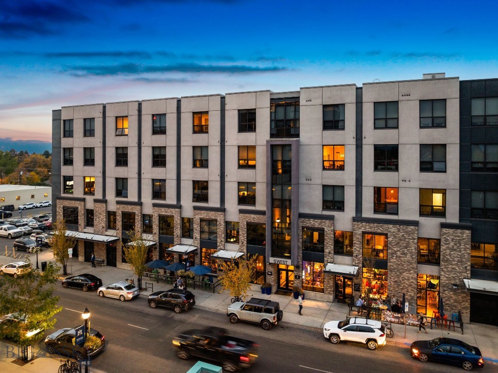 Offering the ideal blend of luxury, space, and location, this 3-bedroom, 3-bath penthouse at 5 W Mendenhall Street, Unit 510 delivers elevated living in the heart of downtown Bozeman. Perched on the top floor of one of the city’s most sought-after luxury buildings, this nearly 2,500-square-foot residence showcases refined design, expansive living spaces, and sweeping mountain views.

A thoughtfully designed open floor plan is enhanced by floor-to-ceiling windows that flood the home with natural light and frame panoramic views of the Bridger Range. The gourmet kitchen features high-end appliances, sleek cabinetry, a generous island, and premium finishes—ideal for entertaining or everyday living. A well-appointed butler’s pantry provides additional prep space, wine storage, and refrigeration.

The spacious living and dining areas create a warm, inviting retreat in the heart of downtown, while residents also enjoy access to a shared rooftop space—perfect for taking in Bozeman’s fresh air and scenic surroundings. The primary suite serves as a private sanctuary with large windows, dual vanities, a walk-in tile shower, and an oversized walk-in closet. Two additional bedrooms and bathrooms offer comfort and flexibility for guests, a home office, or fitness space.

Additional features include engineered hardwood flooring throughout the main living areas, central A/C, custom lighting, and a full-size laundry room with ample storage. Two reserved parking spaces in the secure, heated garage—an exceptional downtown amenity—are included.

Located just one block from Main Street, this penthouse places you moments from Bozeman’s best dining, shopping, entertainment, and community events. From the Emerson to the farmers’ market and nearby trails, everything is within easy reach. This is a rare opportunity to own a luxury penthouse at one of Bozeman’s premier addresses—where vibrant city living meets the comfort and sophistication of a private retreat.