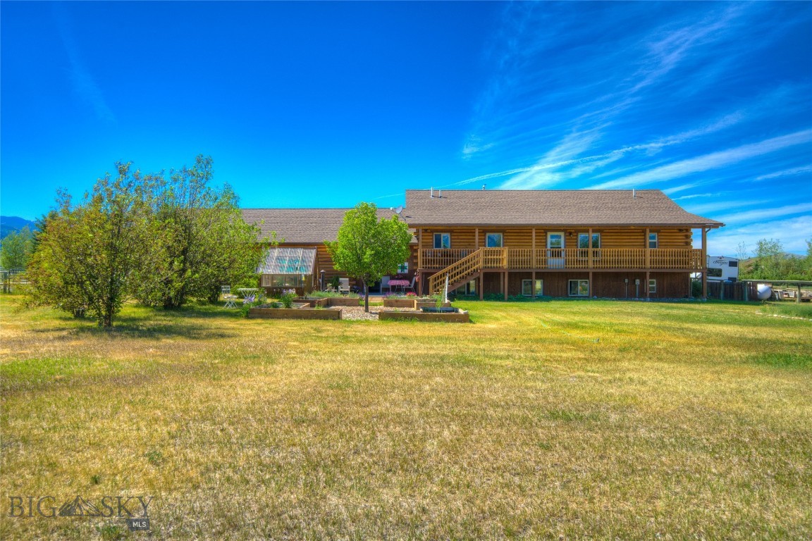 Amazing family home just minutes from Ennis! Enjoy breathtaking views of the Madison range sitting in the shade of your covered porch, or from the courtyard with its mature trees and greenhouse. This beautiful 4bd, 3ba, 3200+/- sqft home - being sold fully furnished has an open feel that flows from the kitchen through the living and dining area with vaulted ceilings and a cozy wood stove. A large family/media room in the basement, enclosed breezeway that leads into a 3 car garage, decks on the front and back, underground sprinklers, and even RV hookups! With it's close proximity to Ennis Lake, and the amenities Ennis has to offer this is your opportunity to live the best life! Currently being used as income generating ABnB!