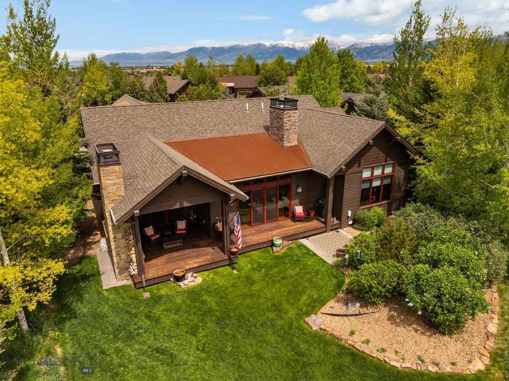 Experience breathtaking views across two fairways, out to the snow-capped Spanish Peaks from this timeless Locati-designed home in the exclusive Black Bull community. Designed for effortless main-level living, the home showcases an open, light-filled layout with classic Montana finishes and exceptional craftsmanship throughout. The great room features a grand stone fireplace and an adjacent wine bar with beverage fridge—perfect for entertaining. From the living or dining areas, step out to the covered redwood deck, where a wood-burning stone fireplace and built-in gas grill create an inviting space to enjoy the expansive golf course and mountain vistas year-round. The chef’s kitchen offers a massive island, walk-in pantry, and upgraded appliances. Each of the three main-level bedrooms includes a private attached bathroom, high ceilings, custom closets and ample space. Upstairs, the spacious 500 sq ft+ bonus room provides flexibility for an office, den, guest space or media room. Additional features include freshly stained cedar siding, wood beam accents, whole house humidifier, water softener with RO system, leaf-filtered gutters, and a heated epoxy-floored garage with extra storage. Set on a quiet cul-de-sac just moments from the Black Bull Club amenities, this residence combines classic design, modern comfort, and unmatched views for the ultimate Montana lifestyle. The Black Bull community offers a championship golf course, pool, fitness center, private restaurant, walking trails, and groomed cross-country ski trails. Please inquire for current club information. Some photos depict club amenities.